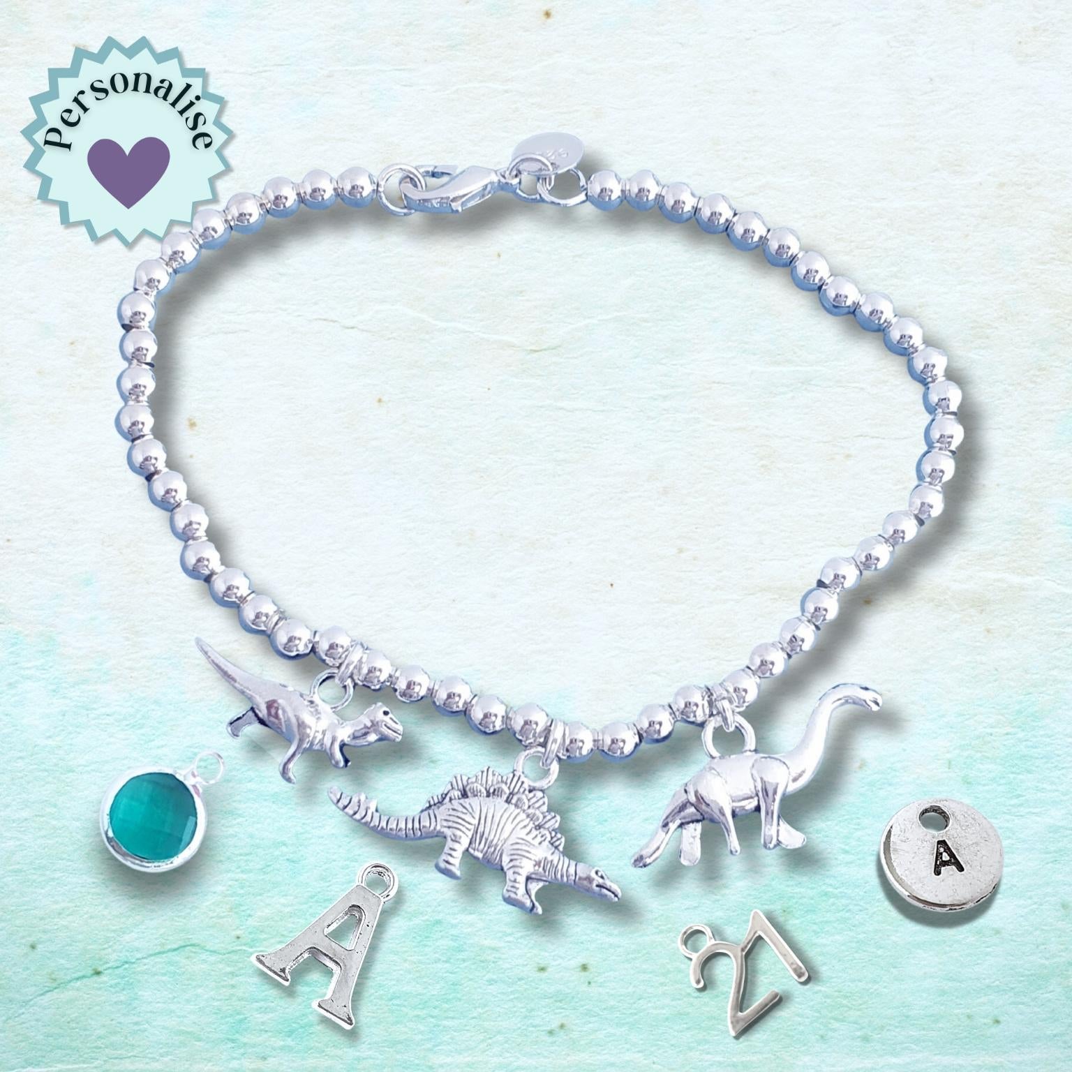 Bracelet with dinosaur charms on a light blue background