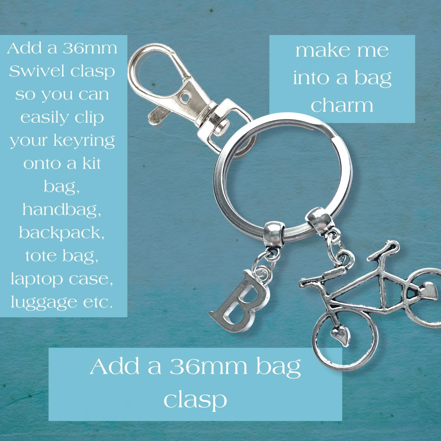 Silver keychain with bicycle charm on a blue background