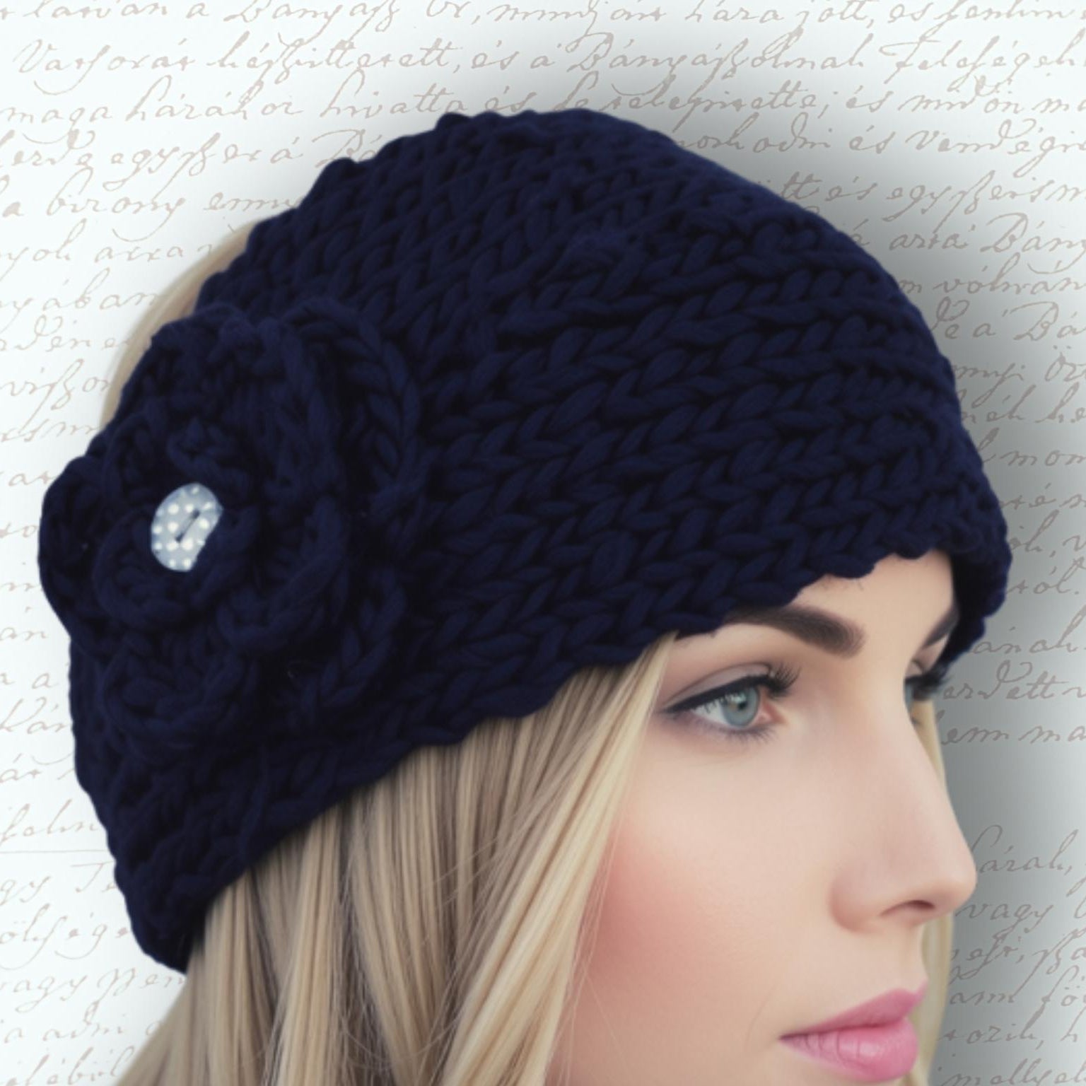 A woman wearing a chunky black knit headband with a large matching flower applique and a small button center, shown in profile against a light script-patterned background.
