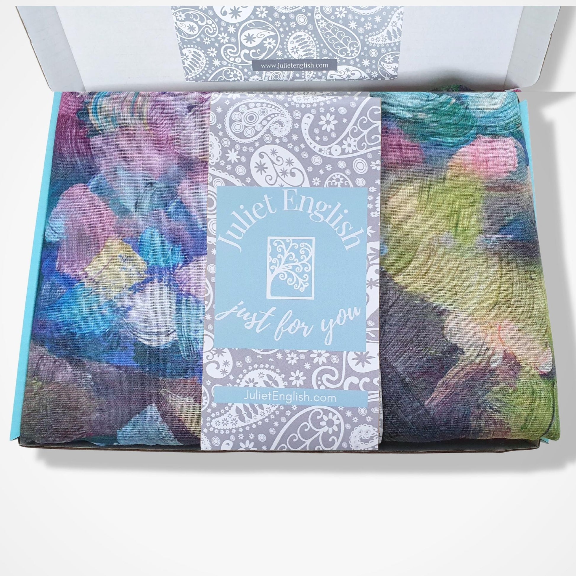 Colorful scarf in a box with 'Juliet English' branding.