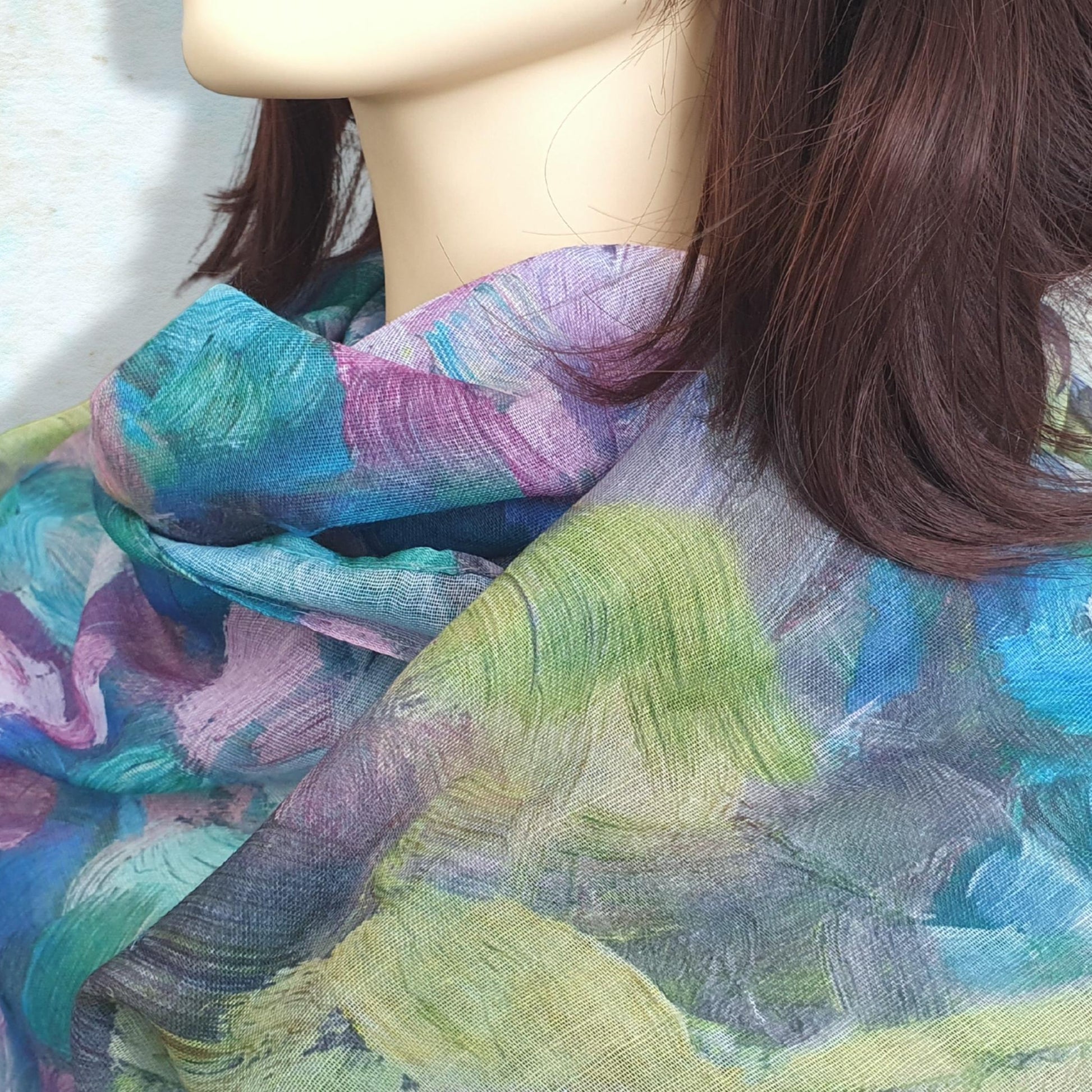Colorful scarf draped over a mannequin with a neutral background