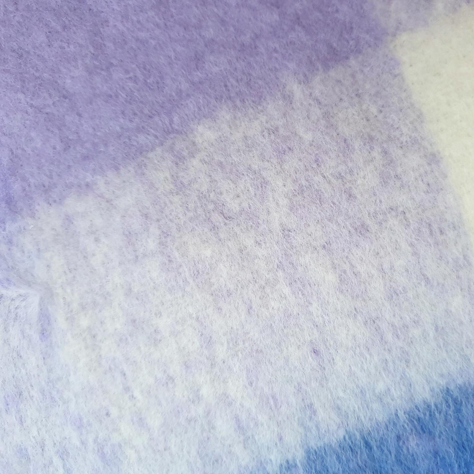 Close-up of scarf with purple, white, and blue colours.