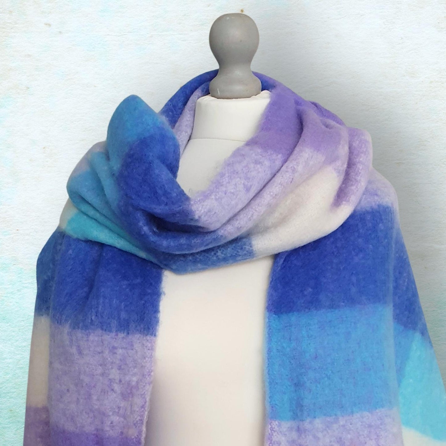 Gradient scarf in blue and purple on a mannequin against a light background