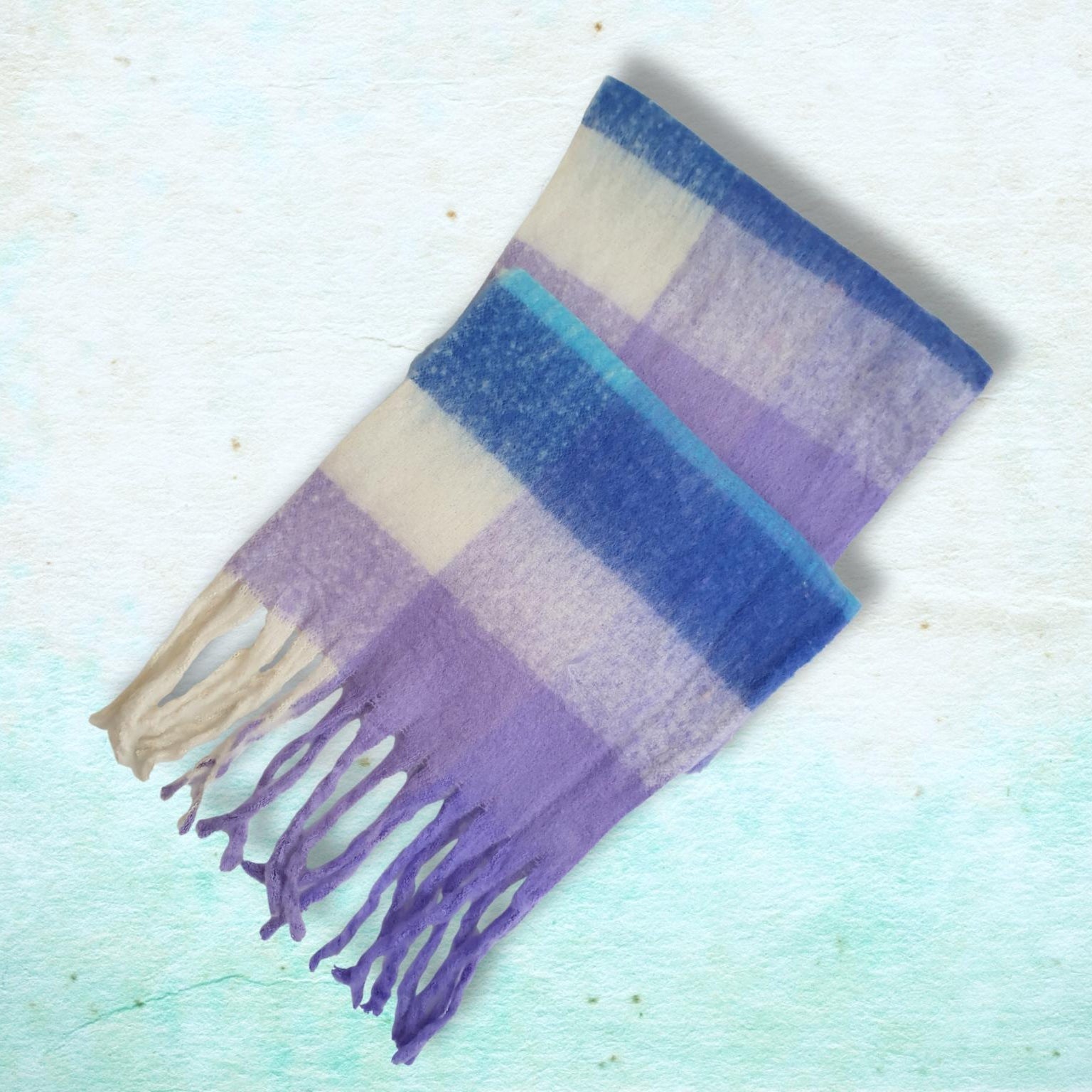 Plaid scarf with purple and blue hues on a light blue background