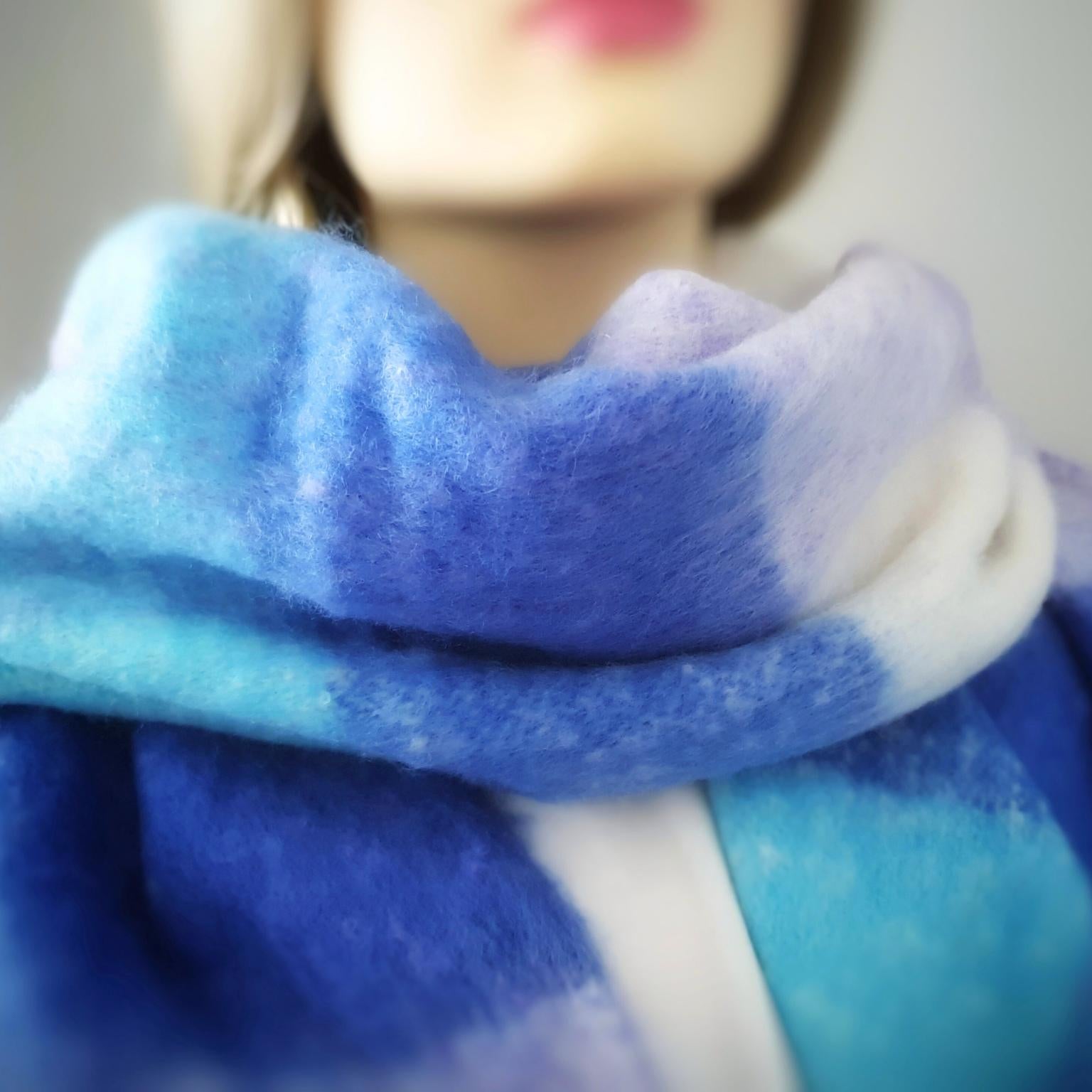 Close-up of a blue, lilac and white scarf on a blurred background