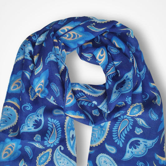 A blue paisley scarf with light blue and beige accents, draped on a white mannequin torso against a light gray background.
