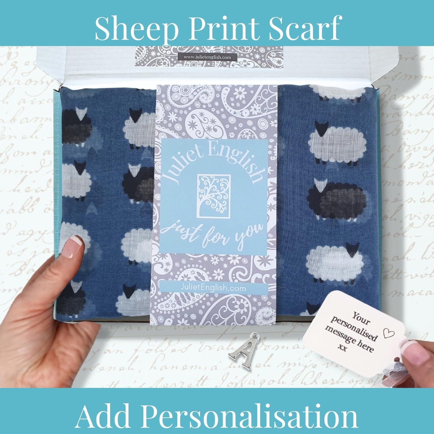 Sheep print scarf with customizable message card held by a hand against a textured white background.