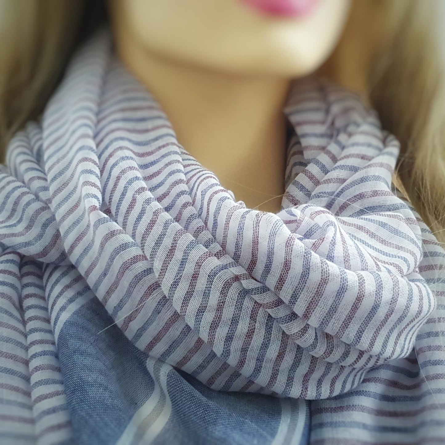 Close-up of a striped scarf on a mannequin with a blurred background