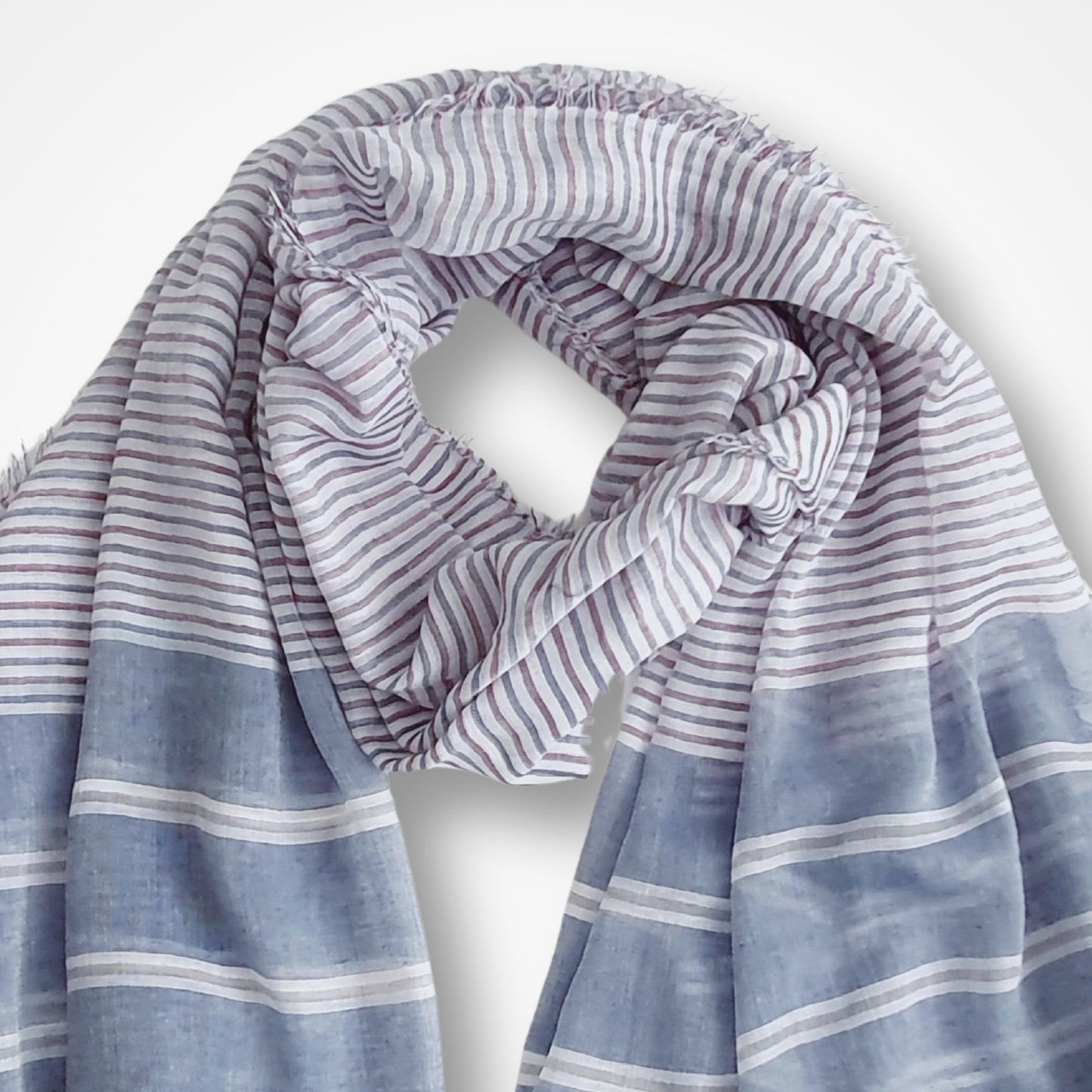 Striped scarf with blue and white colors on a light gray background