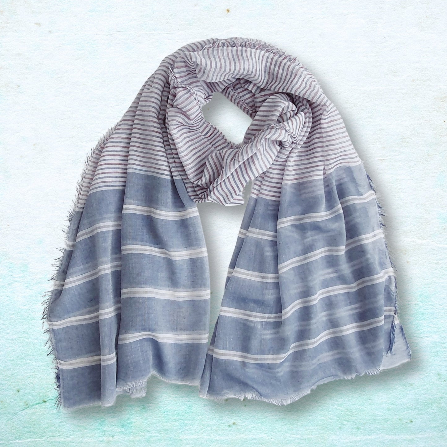 Striped scarf on a light blue textured background