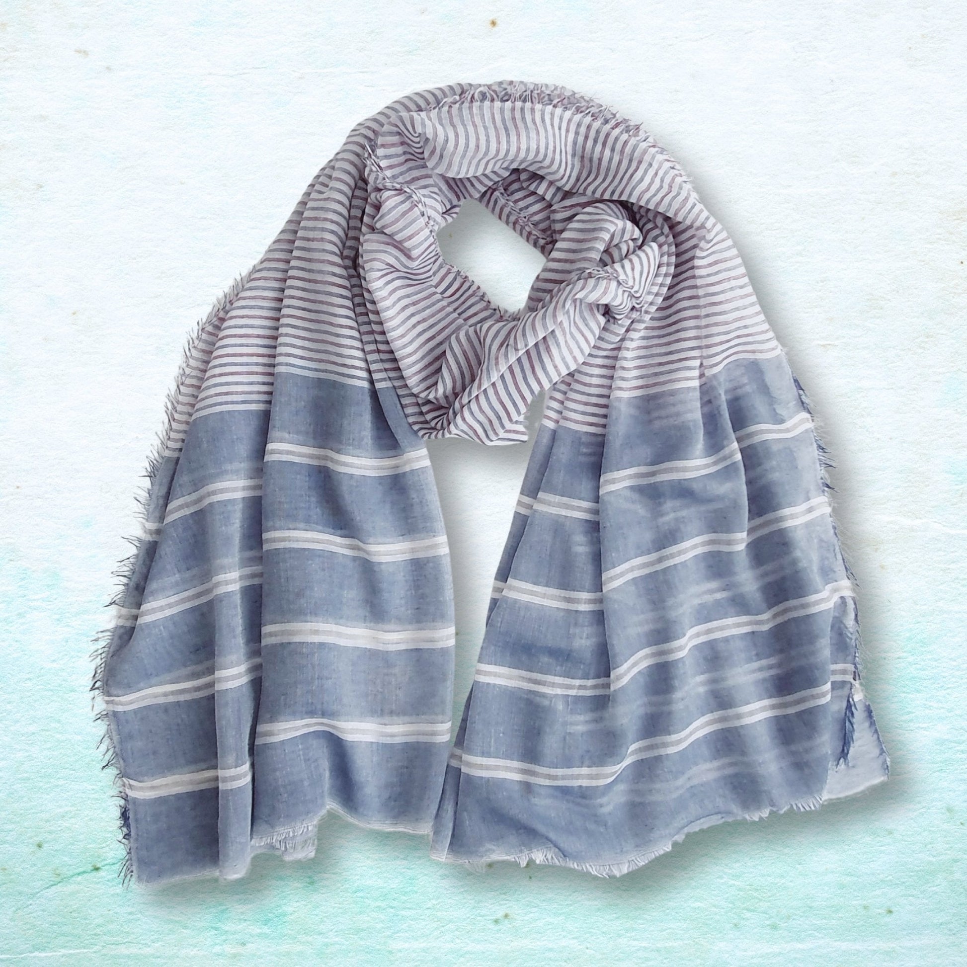 Striped scarf on a light blue textured background