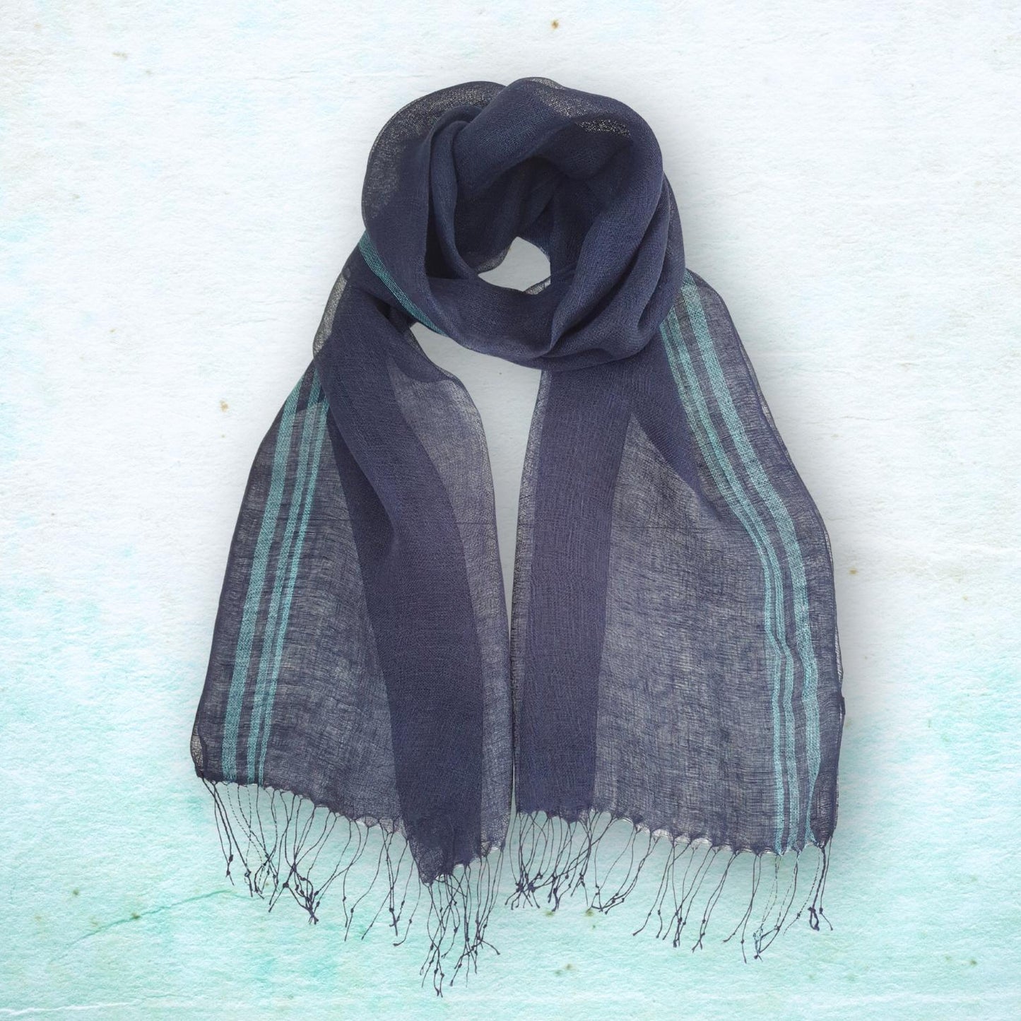 Navy blue scarf with fringes on a light blue textured background