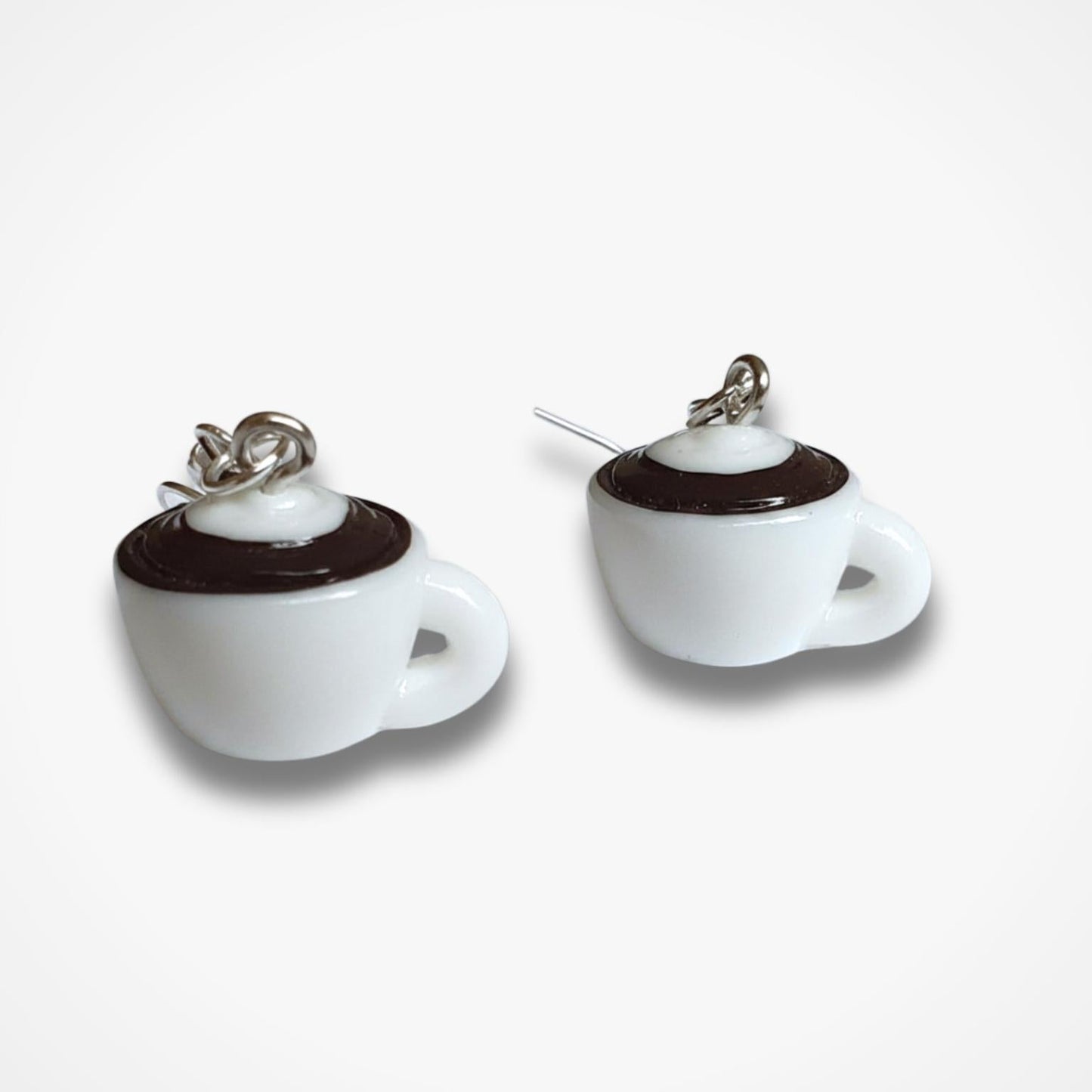 White coffee cup earrings with brown accents on a white background