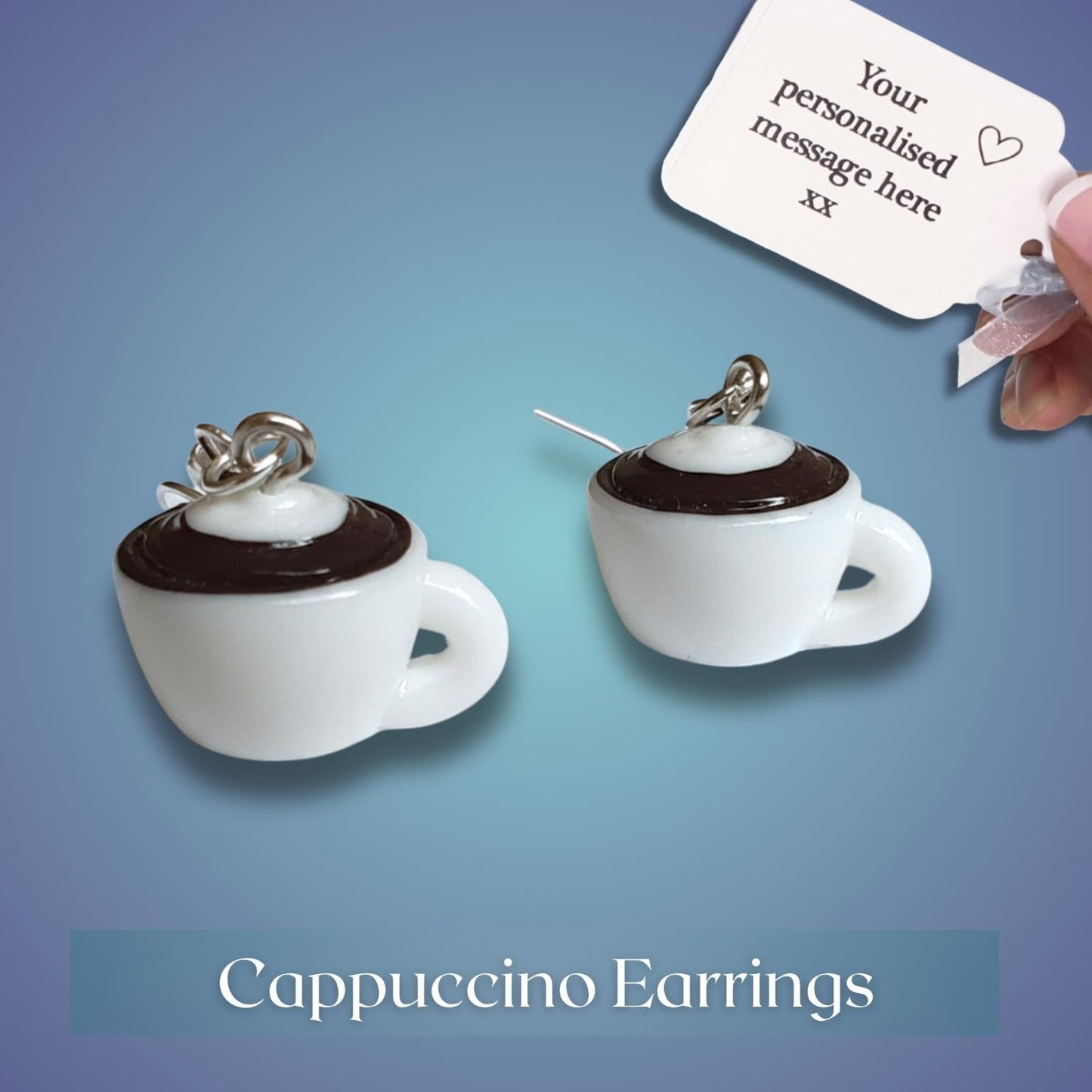 Cappuccino-themed earrings with a hand holding a personalized message card on a gradient blue background.