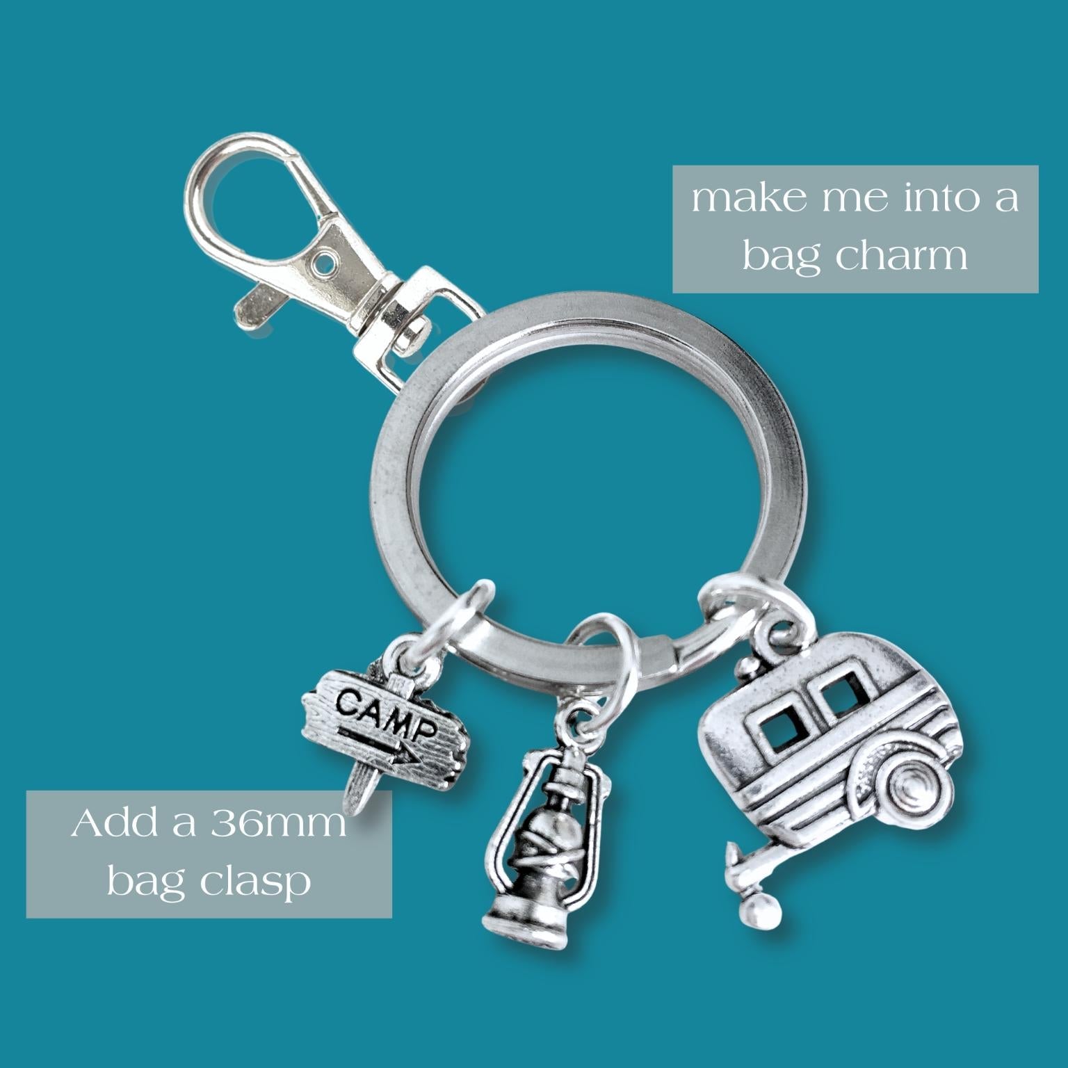 Silver keychain with camping-themed charms on a teal background