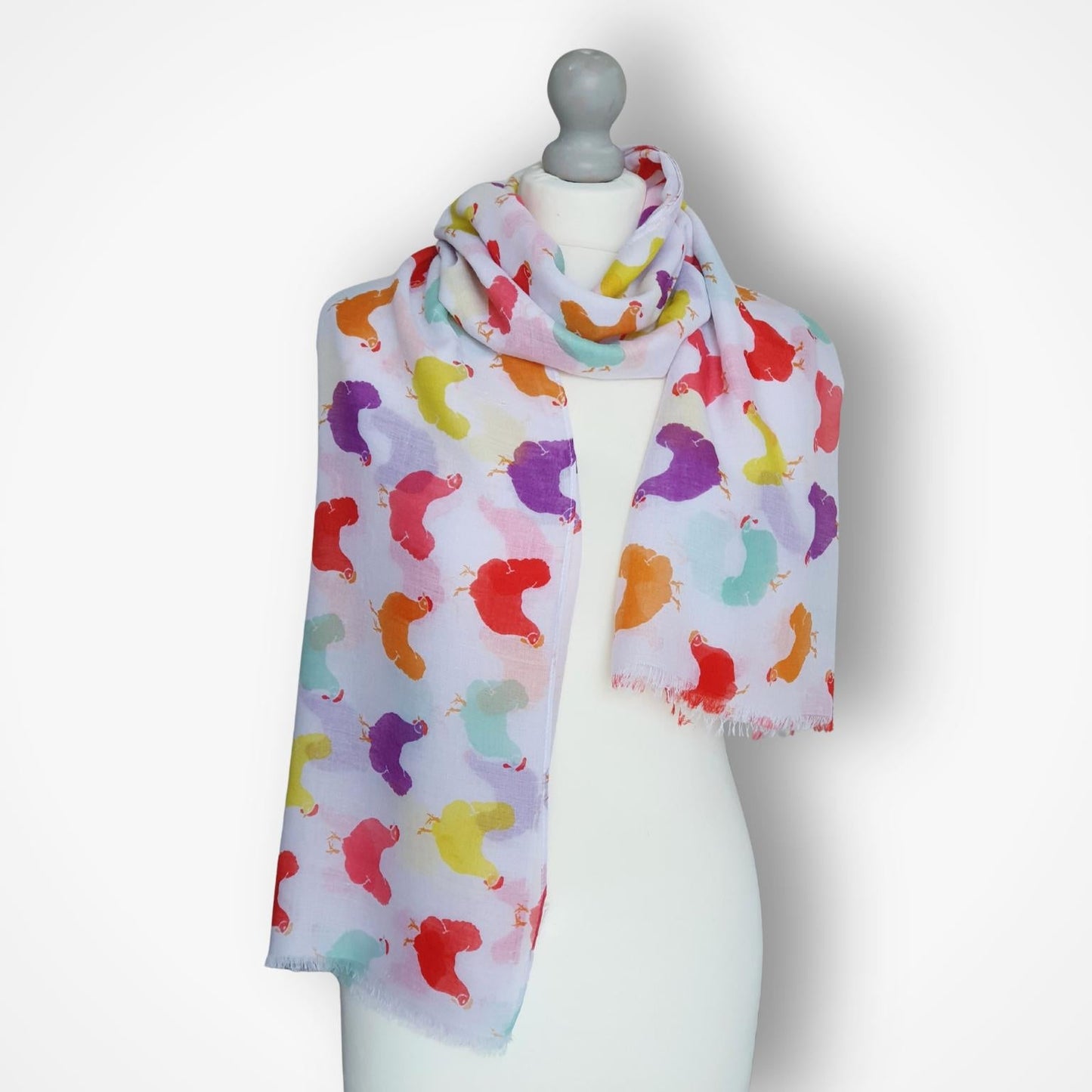 Colorful scarf with hens pattern on a mannequin against a white background