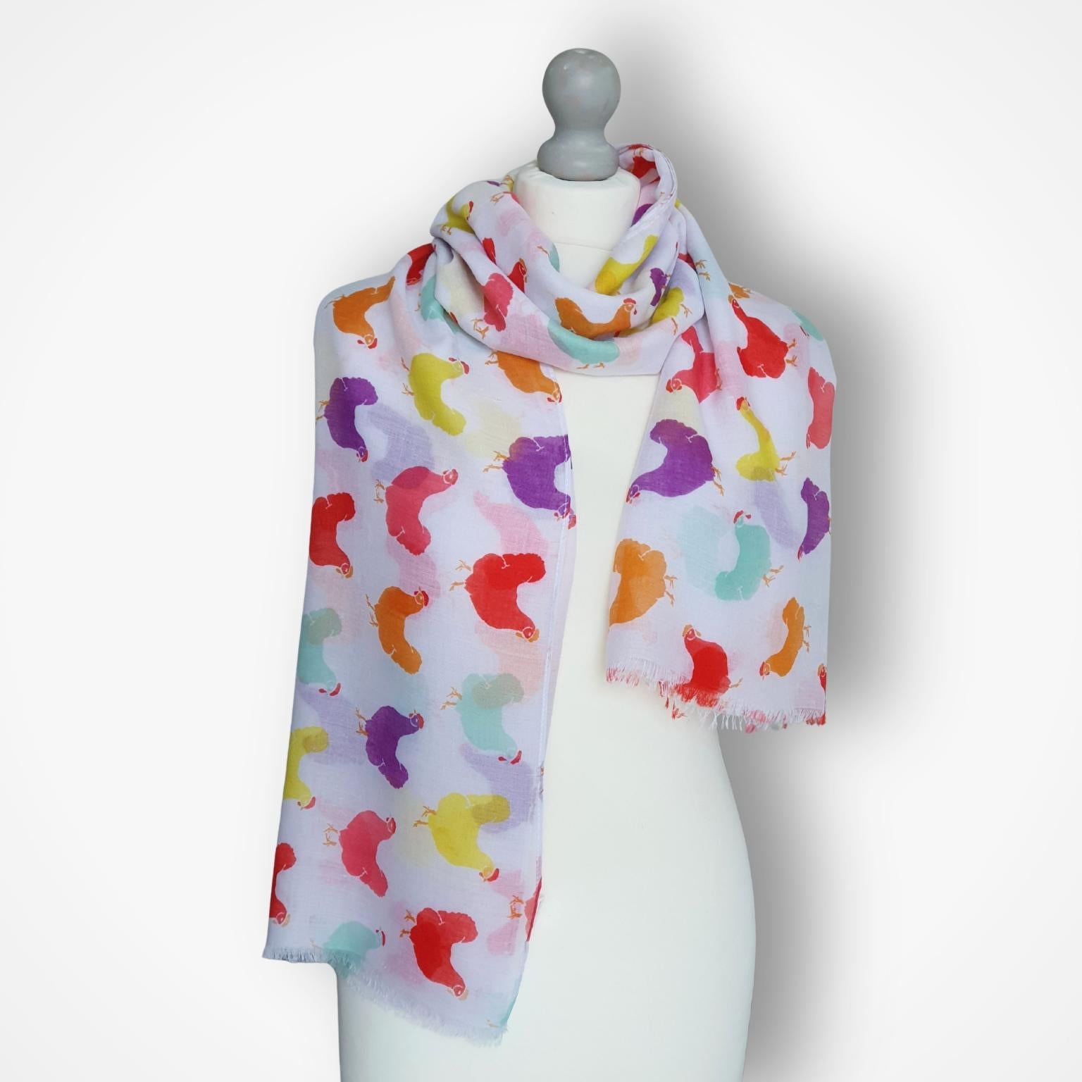 Colorful scarf with hens pattern on a mannequin against a white background