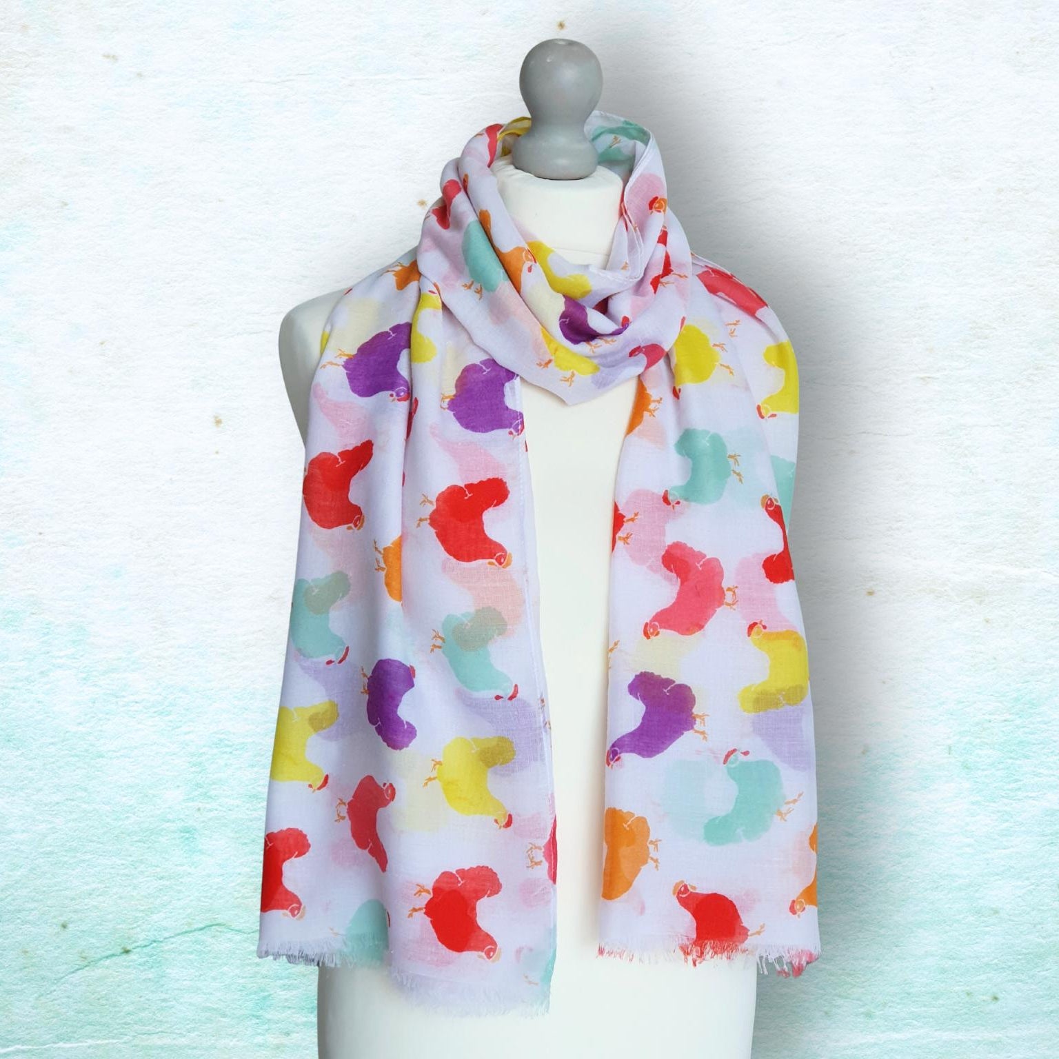 Colorful patterned scarf on a mannequin against a light background