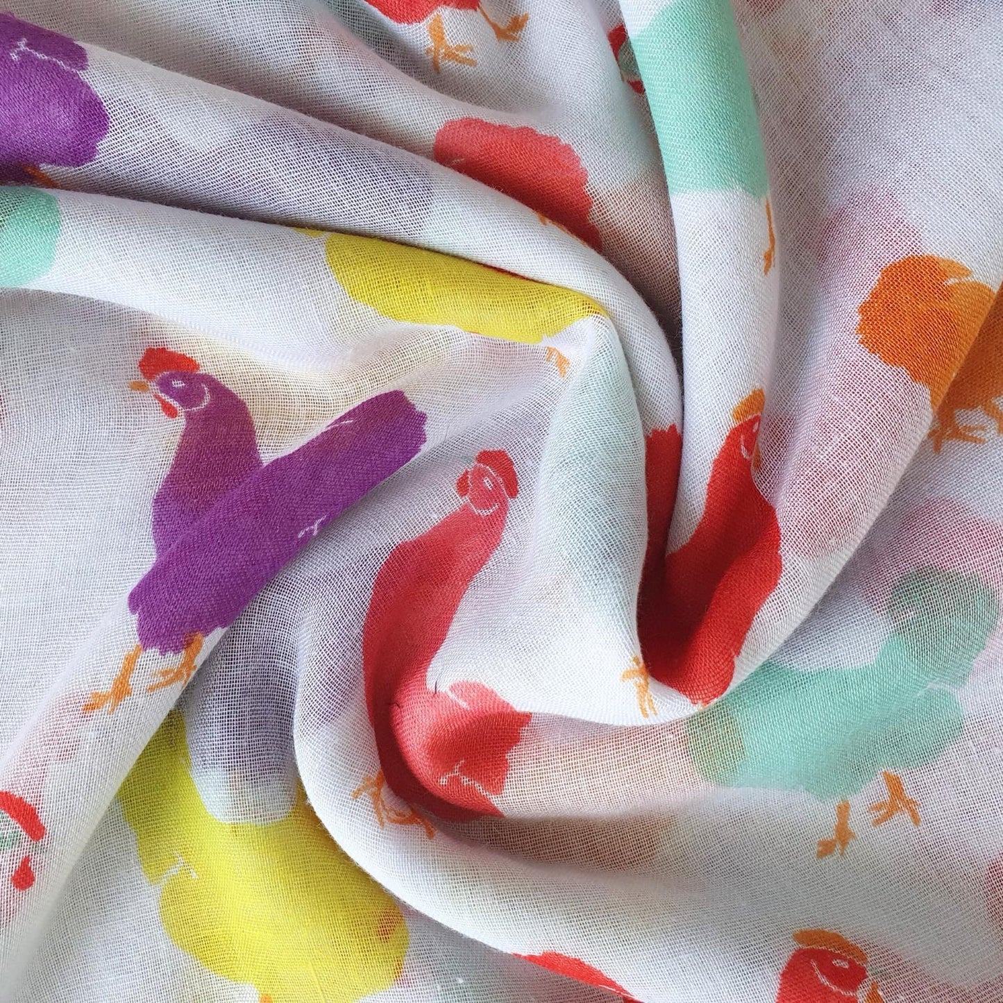 Colorful fabric with chicken patterns on a white background