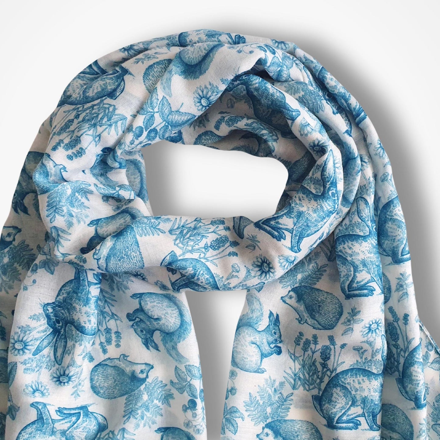 Blue and white patterned scarf on a white background