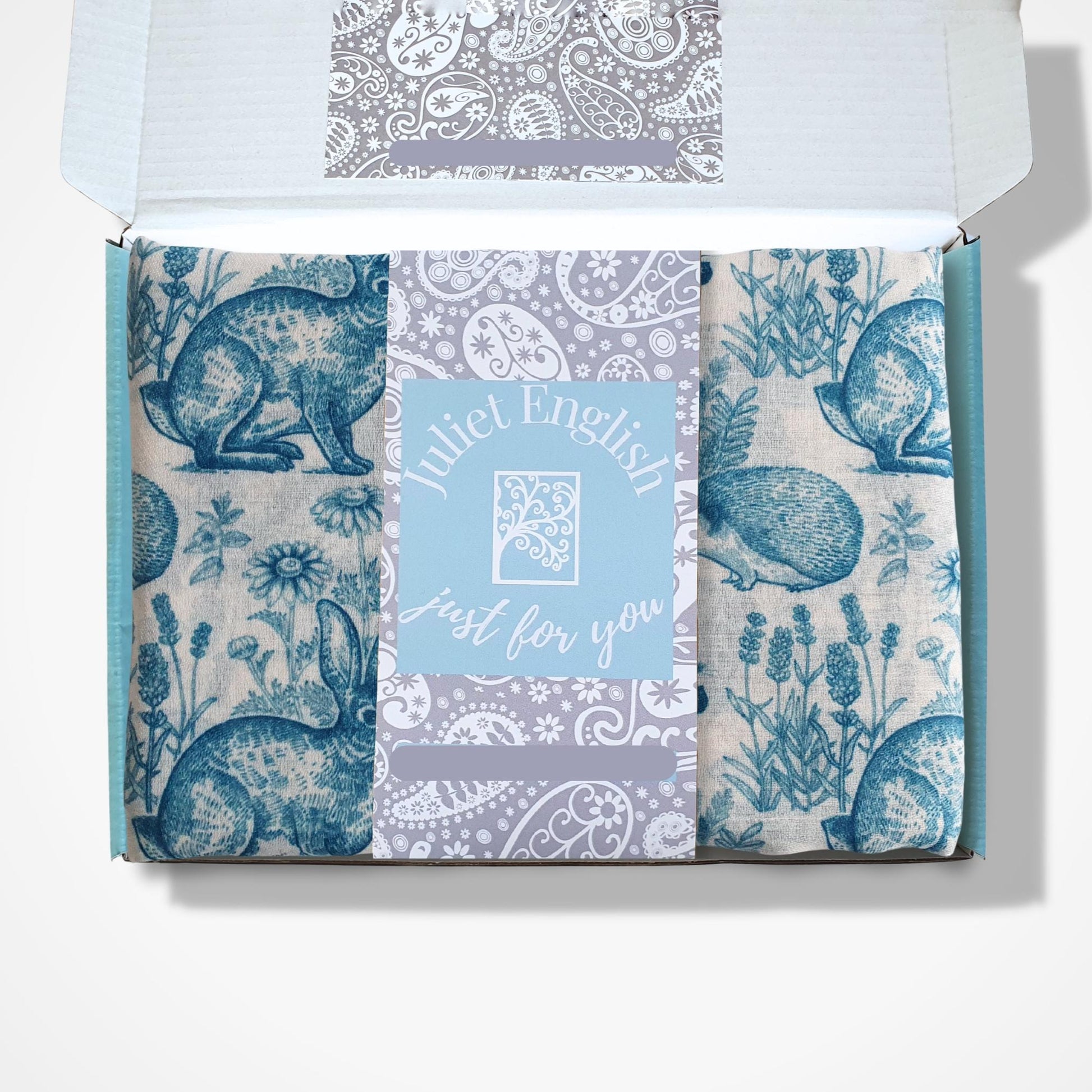 Rabbit, hedgehog and squirrel designs scarf in a 'Juliet English' box on a white background
