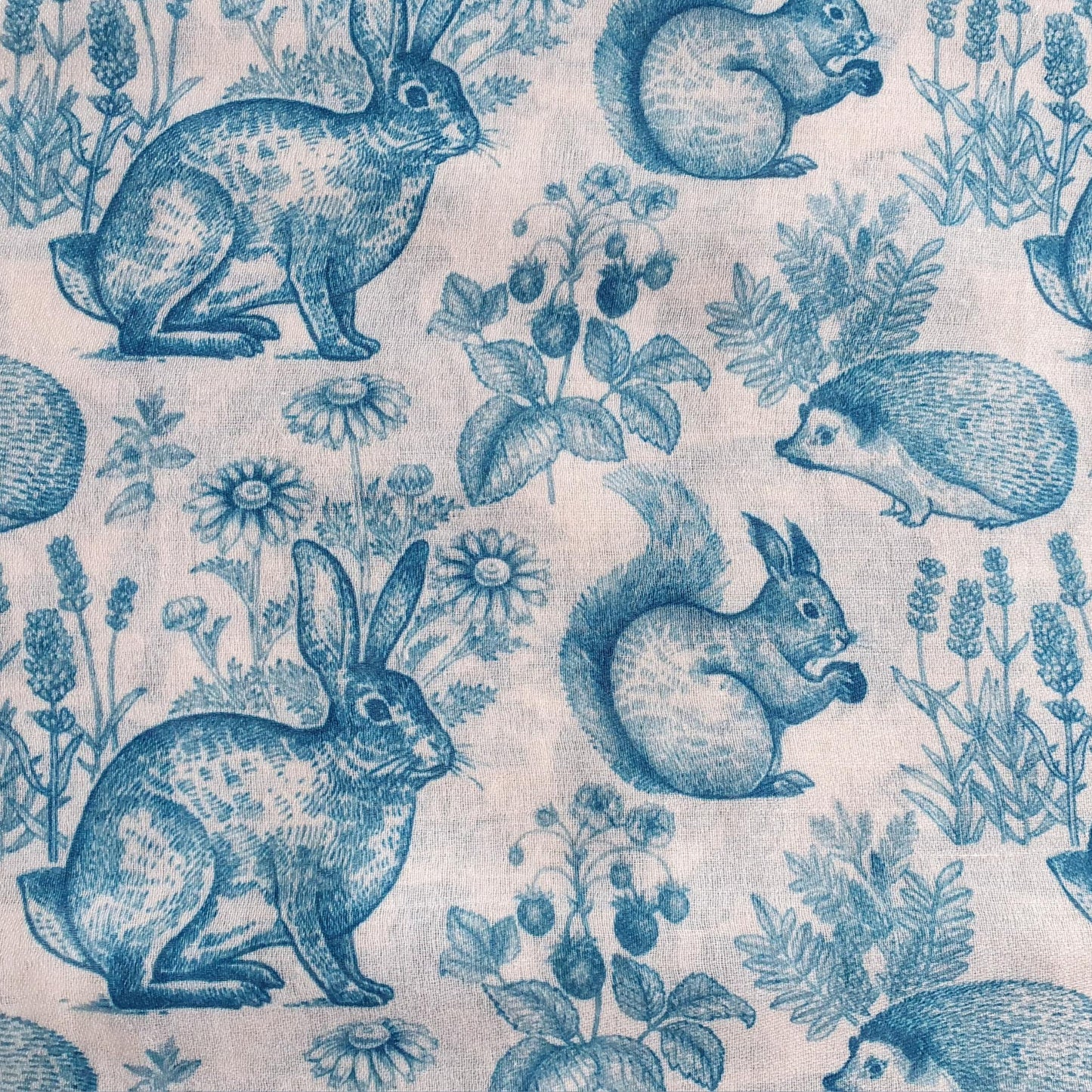 Pattern of blue animals and plants on a light background