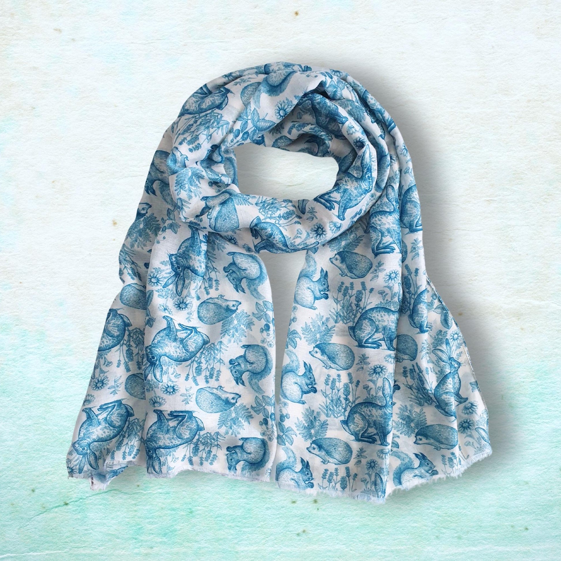 Blue patterned woodland animal scarf on a light blue background