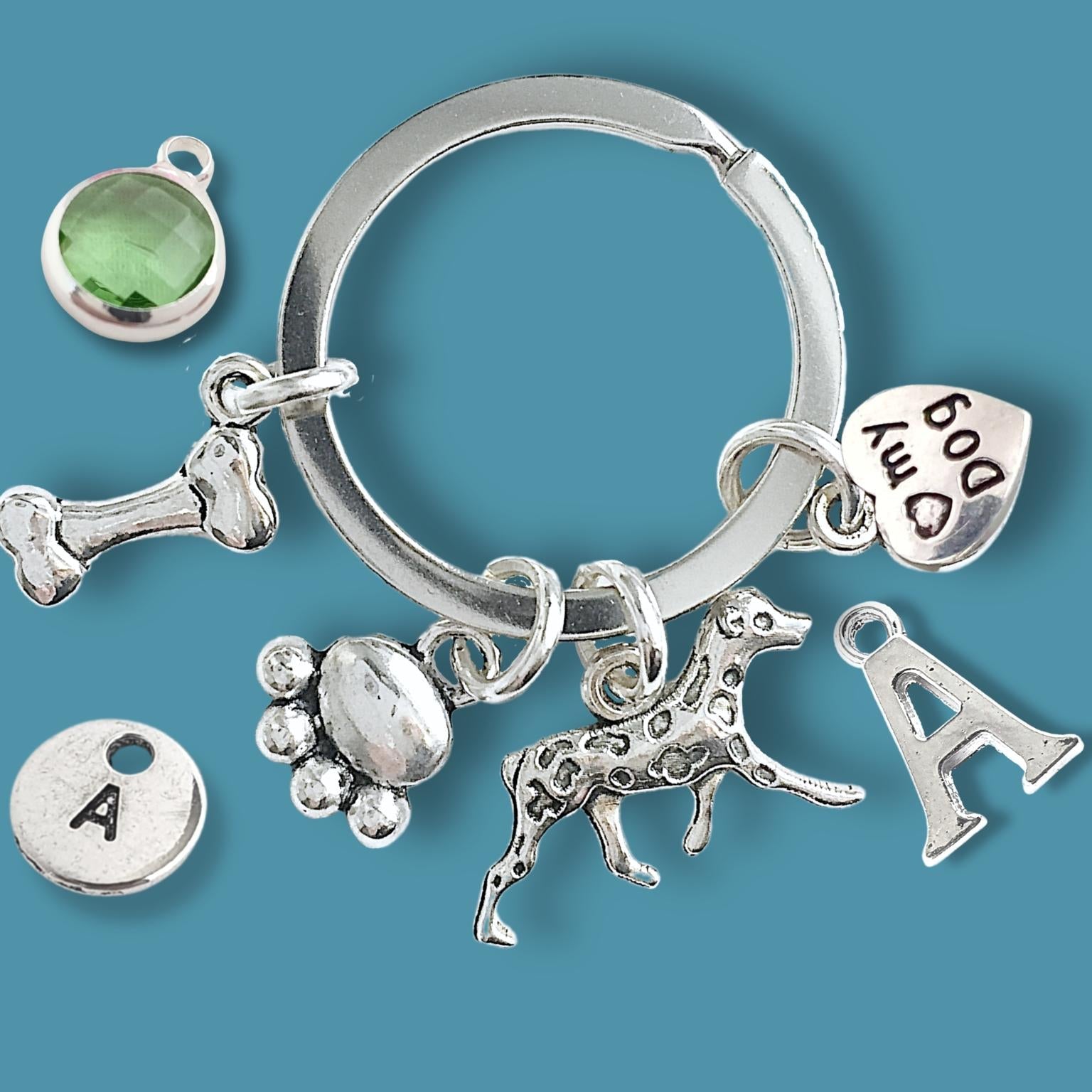 Silver keychain with various charms on a blue background