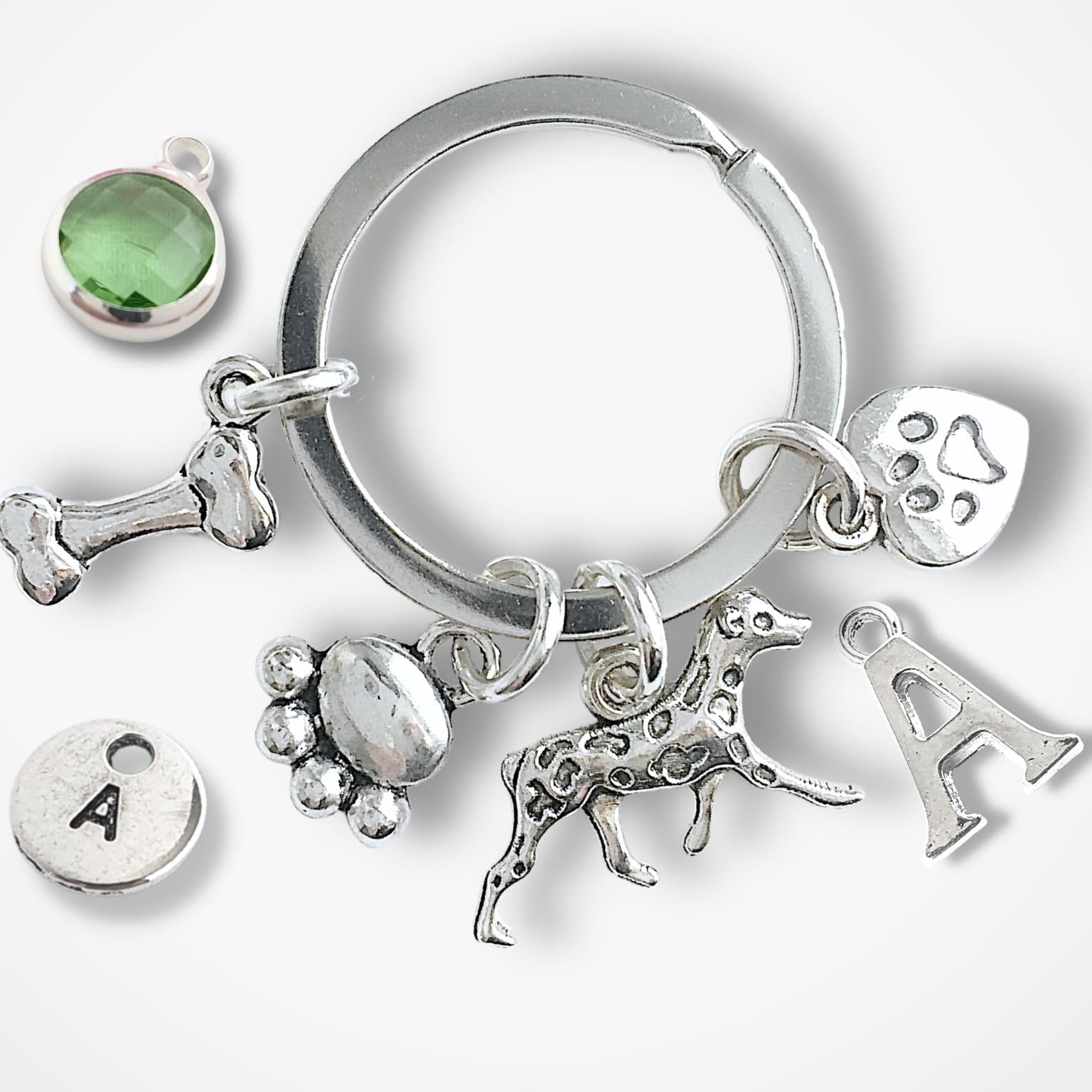 Silver keychain with various charms on a white background