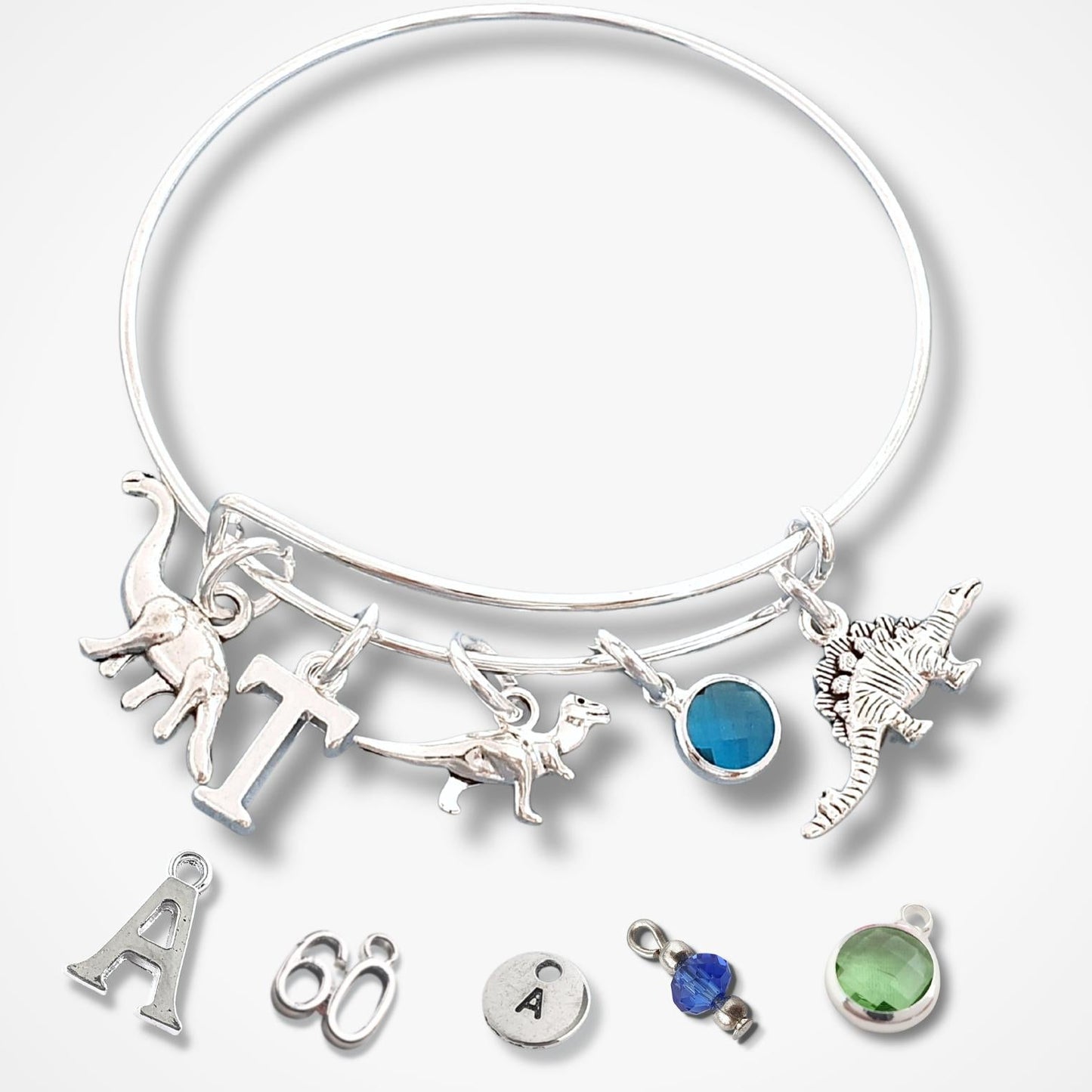 Silver bracelet with various charms on a white background