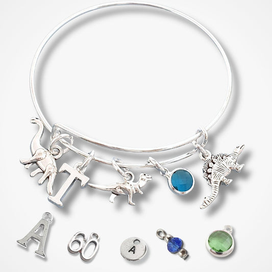 Silver bracelet with various charms on a white background