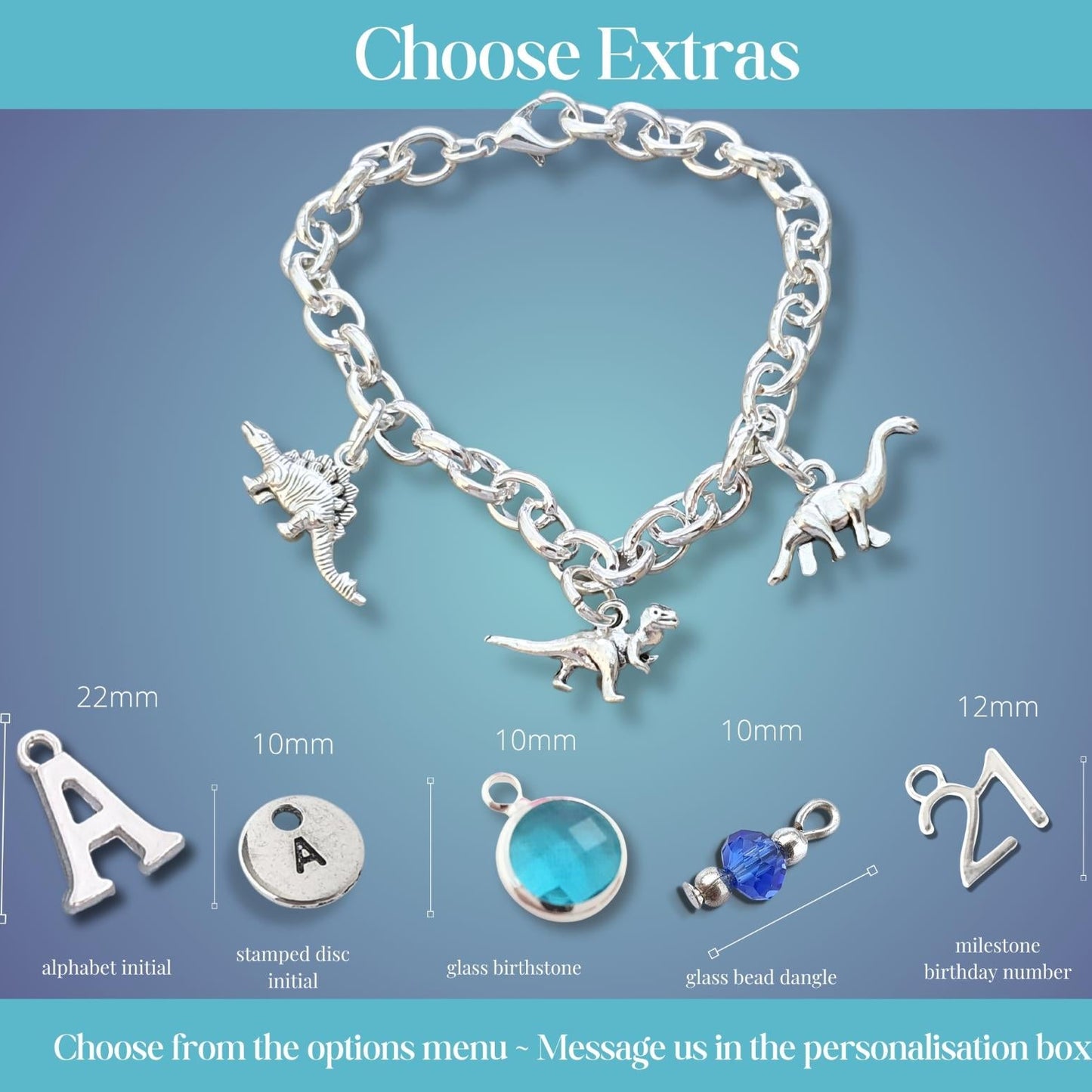 A silver chain bracelet with dinosaur charms displayed on a blue gradient background, with labeled options for extra personalization charms and dimensions below. Text at the top reads 'Choose Extras' and the bottom note says to choose from options menu and message in the personalisation box.