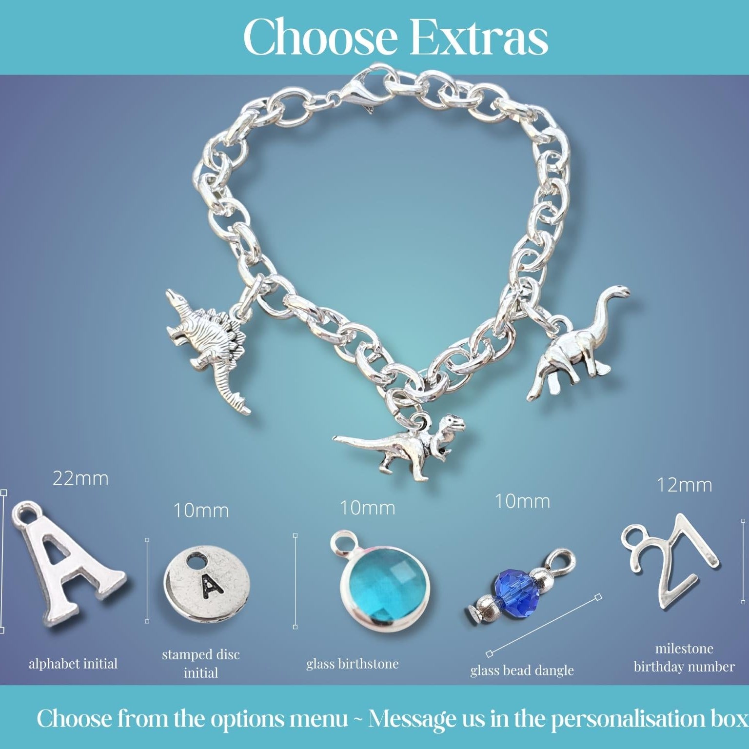 A silver chain bracelet with dinosaur charms displayed on a blue gradient background, with labeled options for extra personalization charms and dimensions below. Text at the top reads 'Choose Extras' and the bottom note says to choose from options menu and message in the personalisation box.