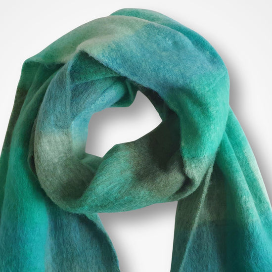 Green blanket scarf on a white background