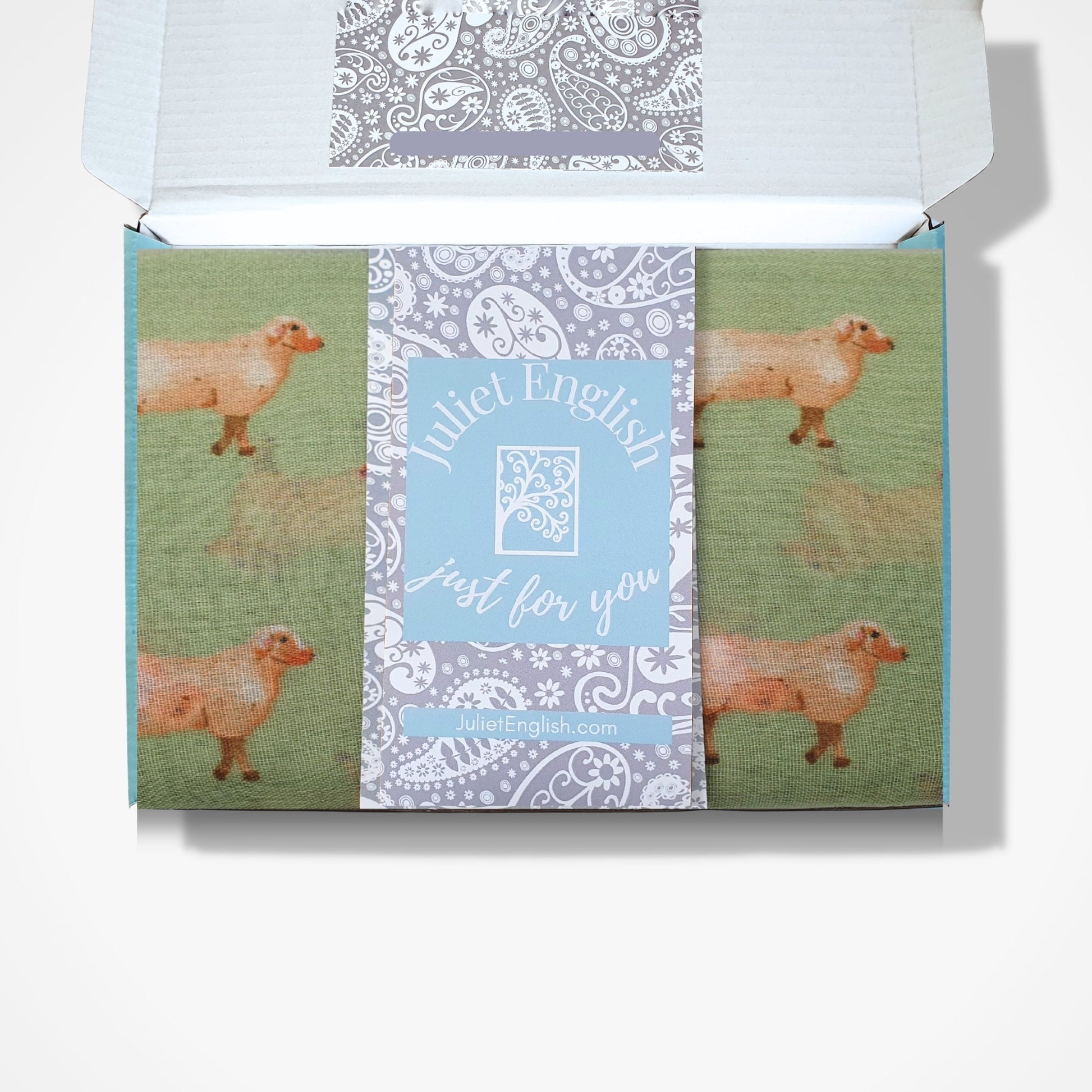 Scaarf with sheep design in a box and 'Juliet English' branding on a white background