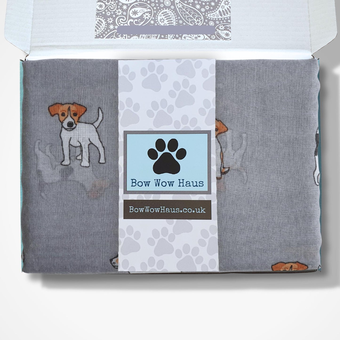 Jack Russell dog-themed scarf in a box with visible brand logo on a white background