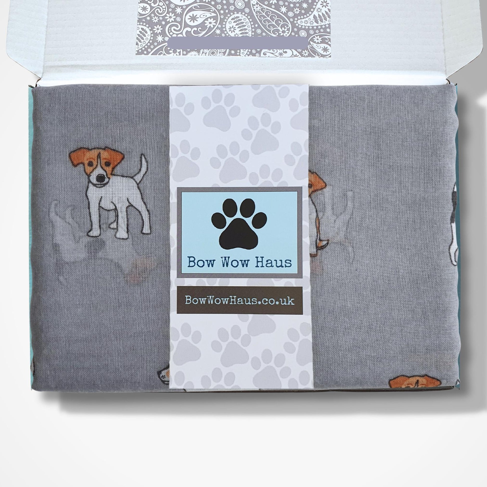 Jack Russell dog-themed scarf in a box with visible brand logo on a white background