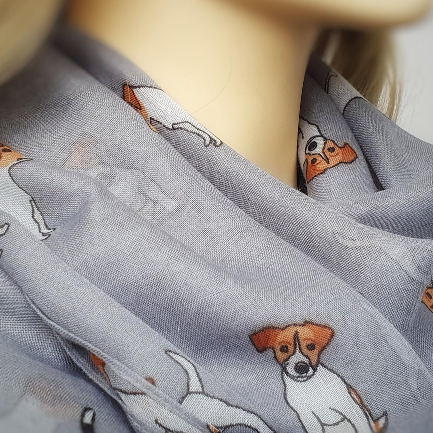 Gray scarf with jack russell dog illustrations on a mannequin