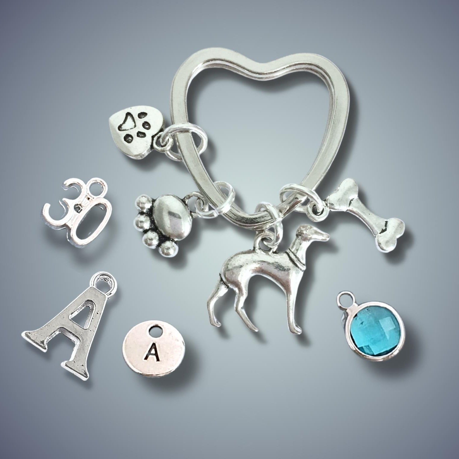 Silver keychain with various charms on a gray background