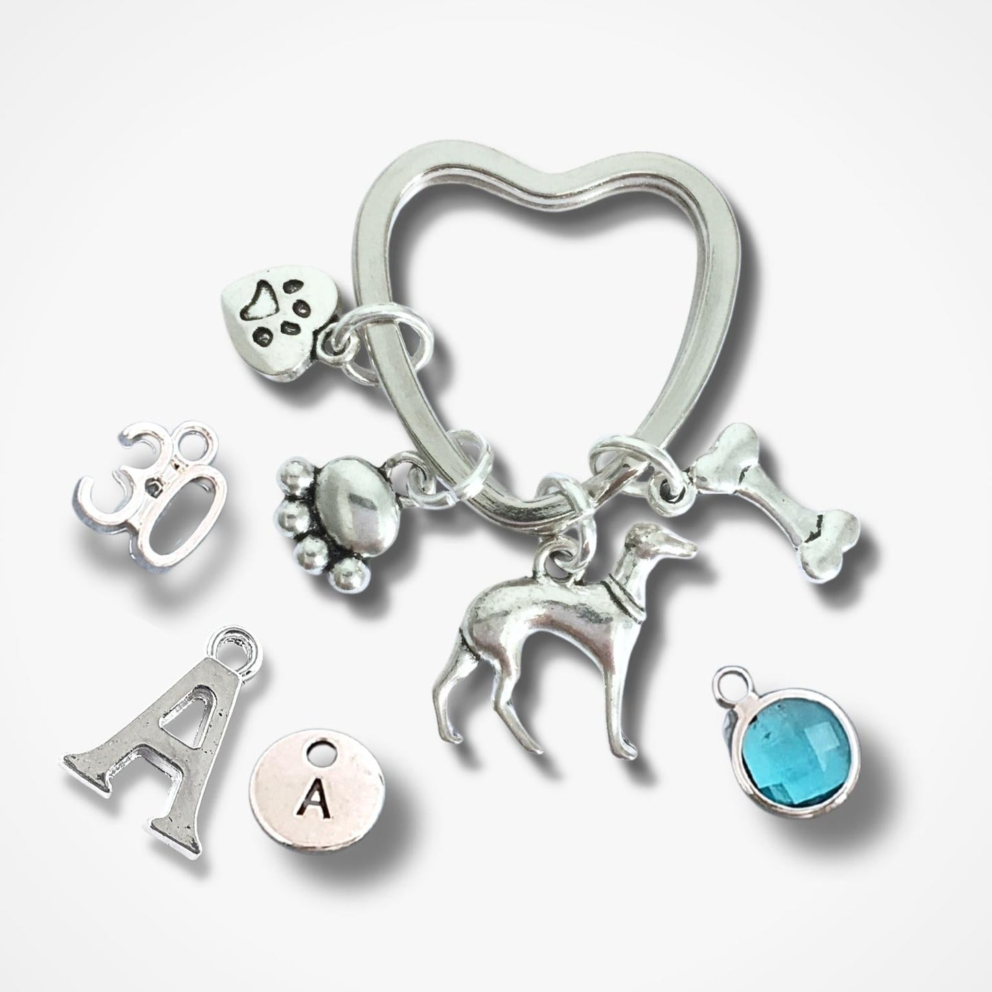 Silver keychain with various charms on a white background