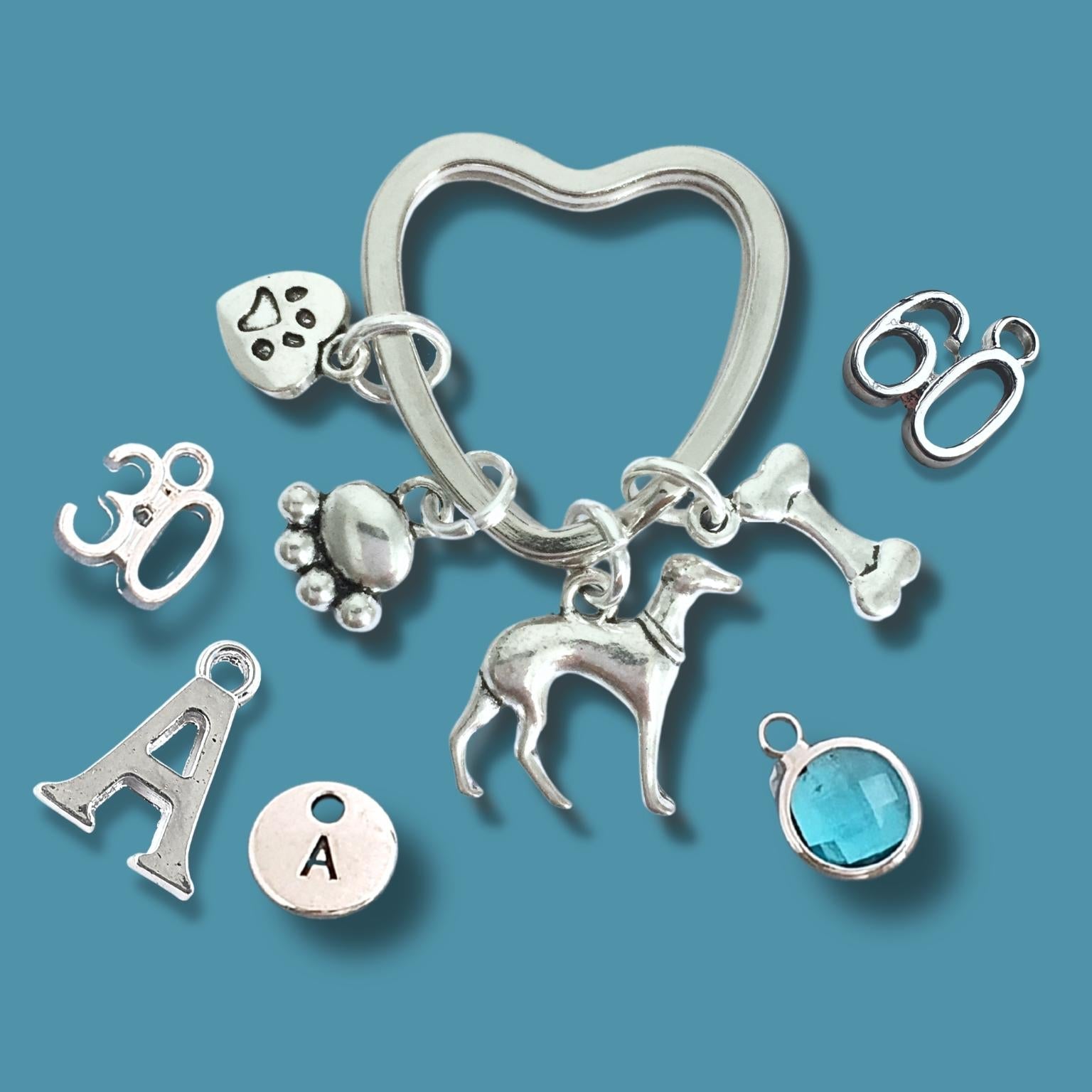 Silver keychain with various charms on a blue background