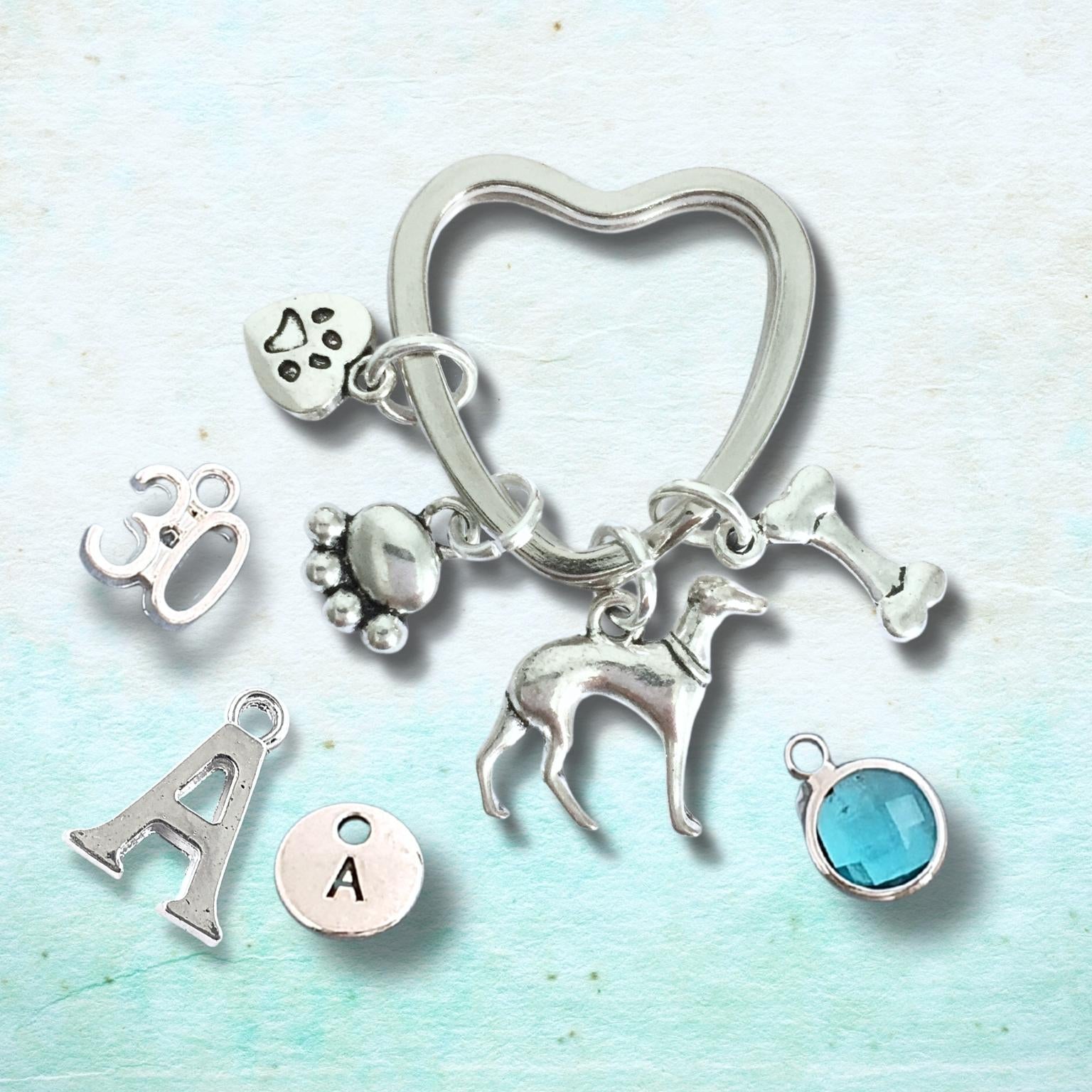 Silver keychain with various charms on a light blue background