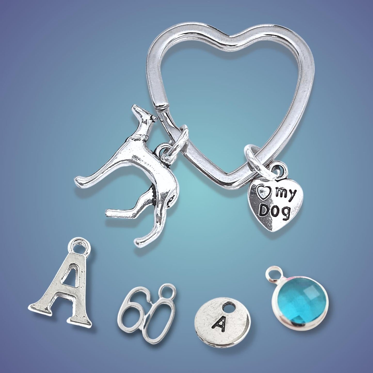 Silver heart-shaped keychain with various charms on a gradient blue background