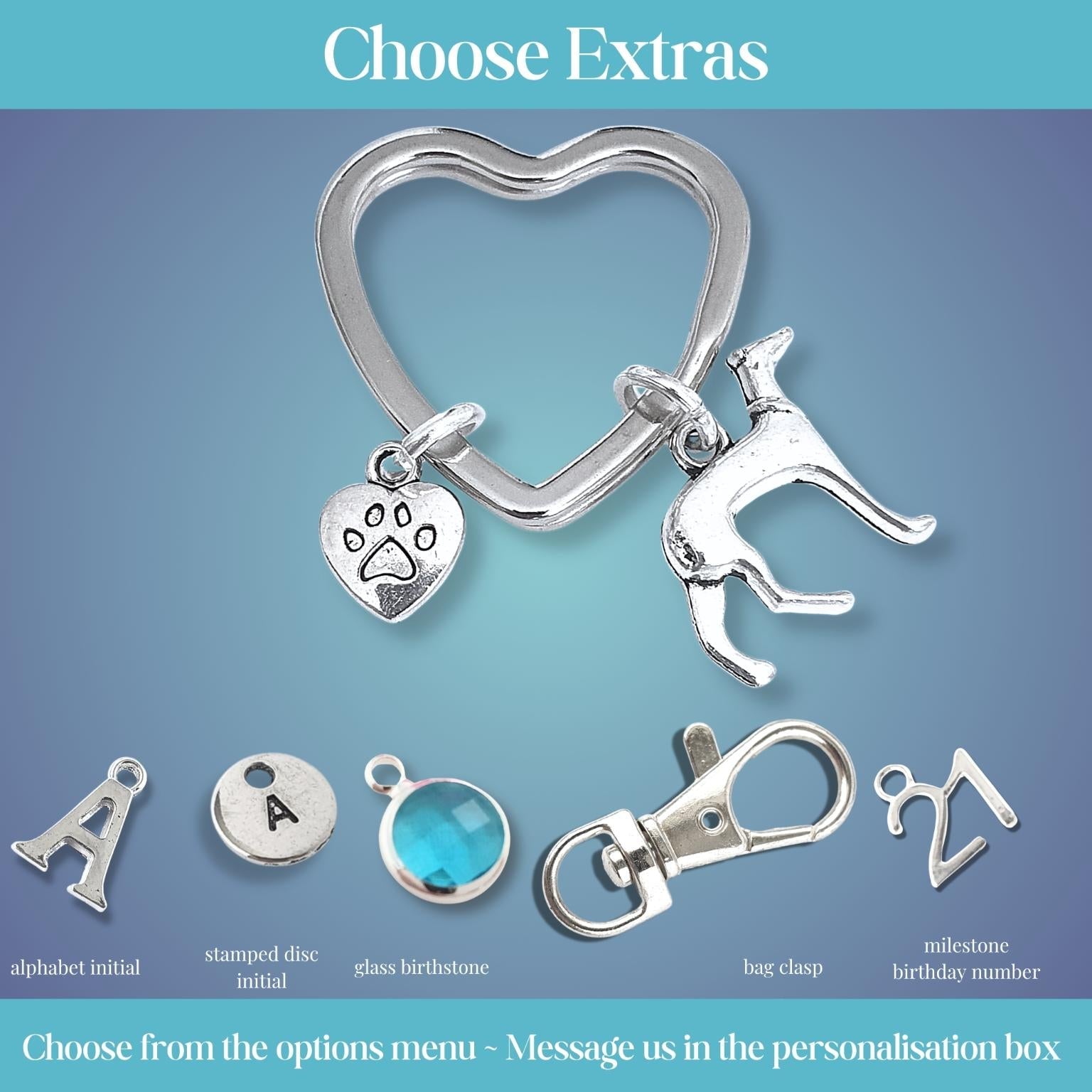 Silver heart-shaped keychain with dog and paw print charms on a blue gradient background