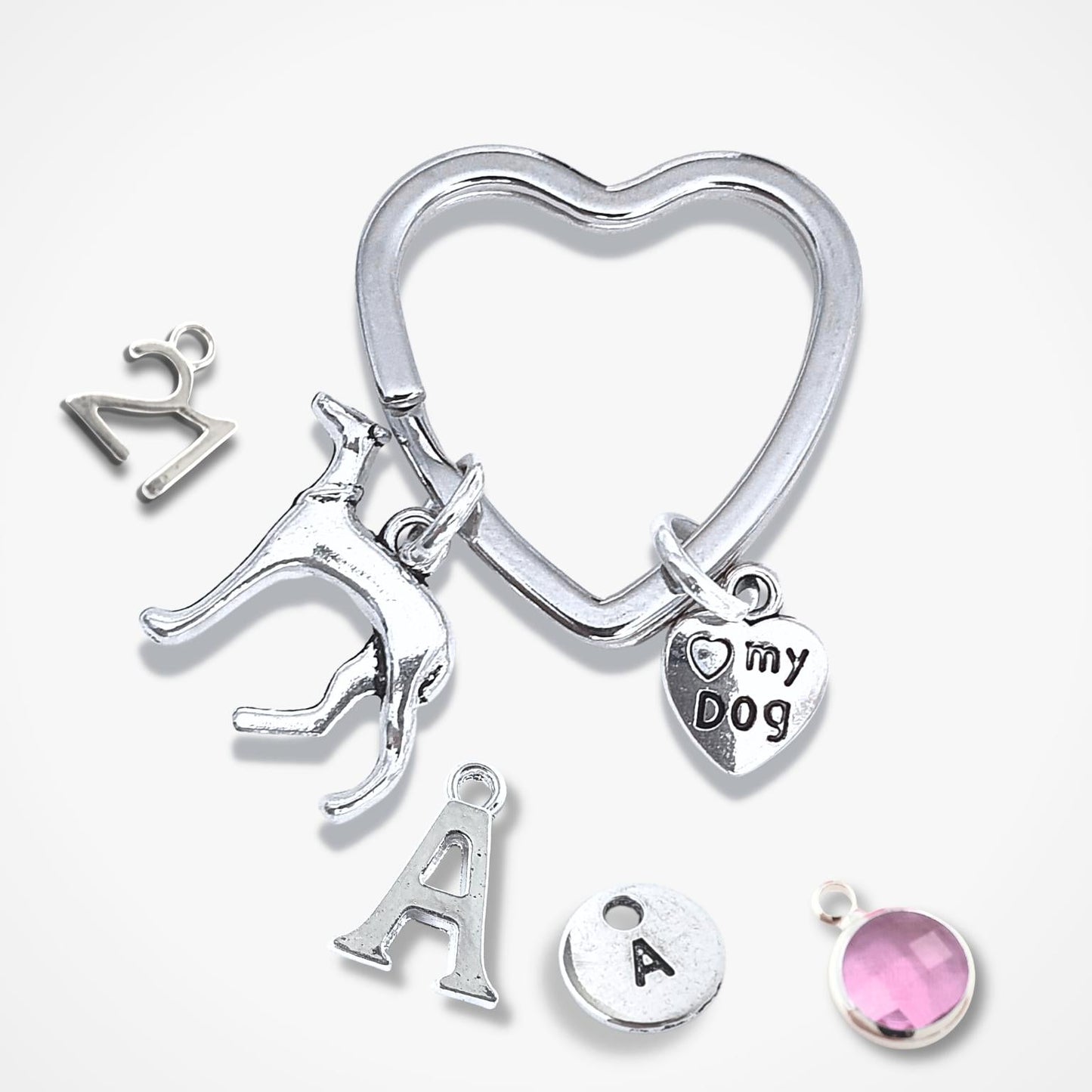 Silver keychain with various charms on a white background