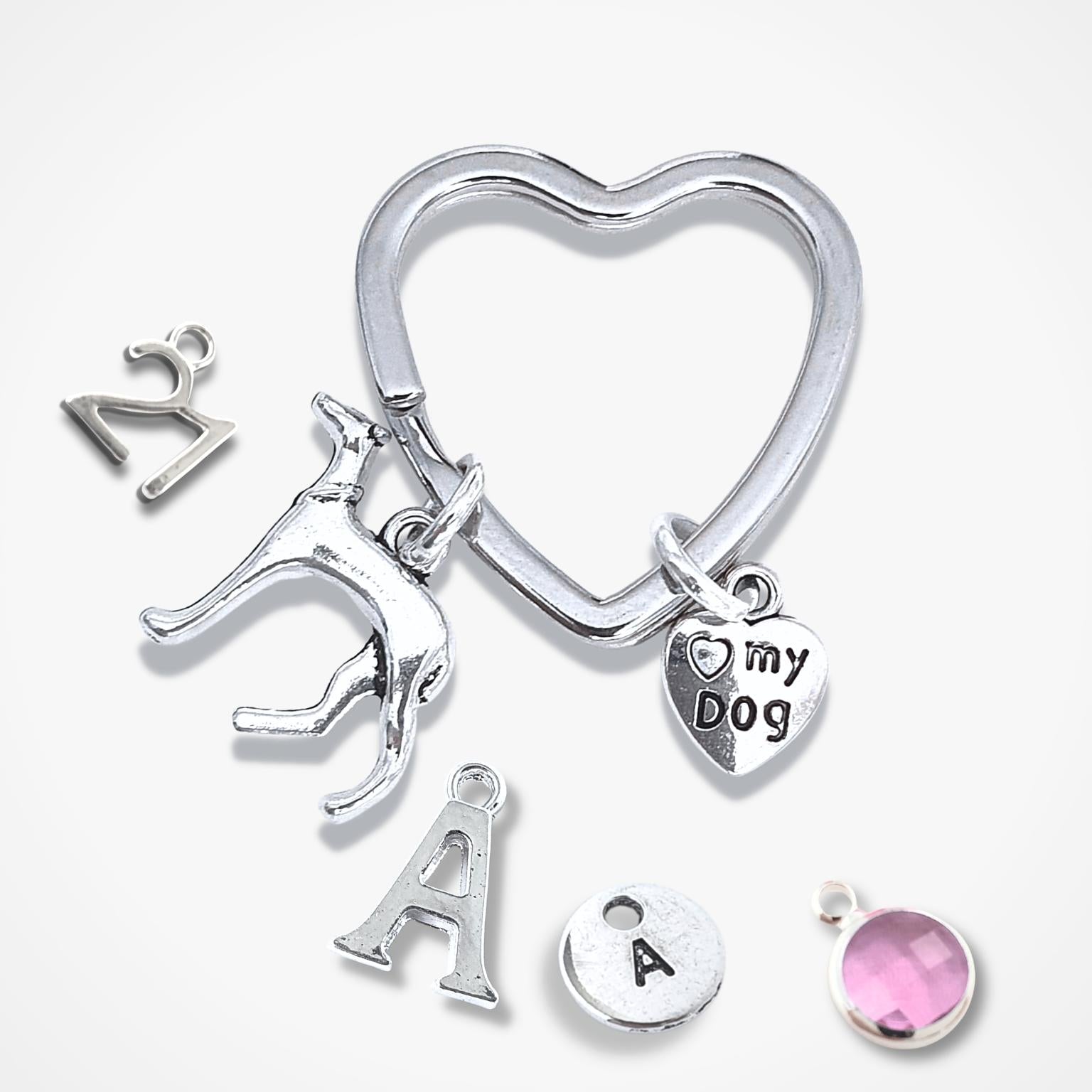 Silver keychain with various charms on a white background