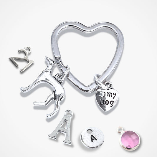 Silver keychain with various charms on a white background