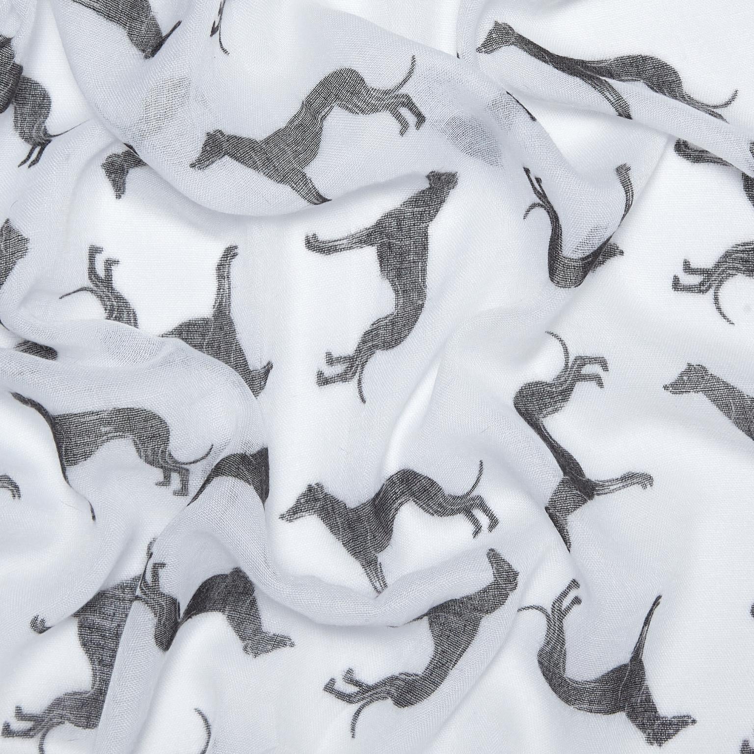 White lightweight fabric with an allover print of black greyhound silhouettes, shown in soft folds.