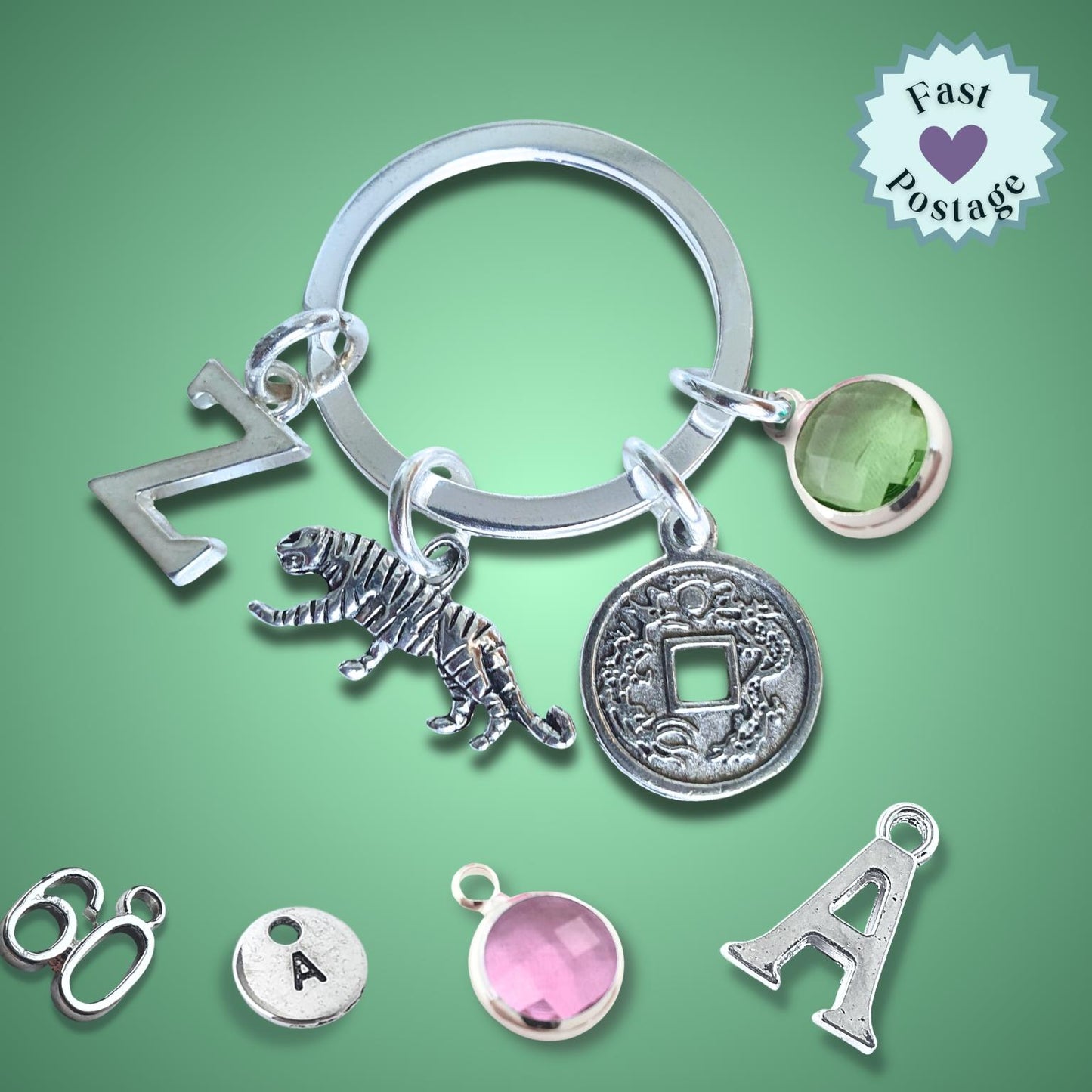 Silver keychain with various charms on a green background