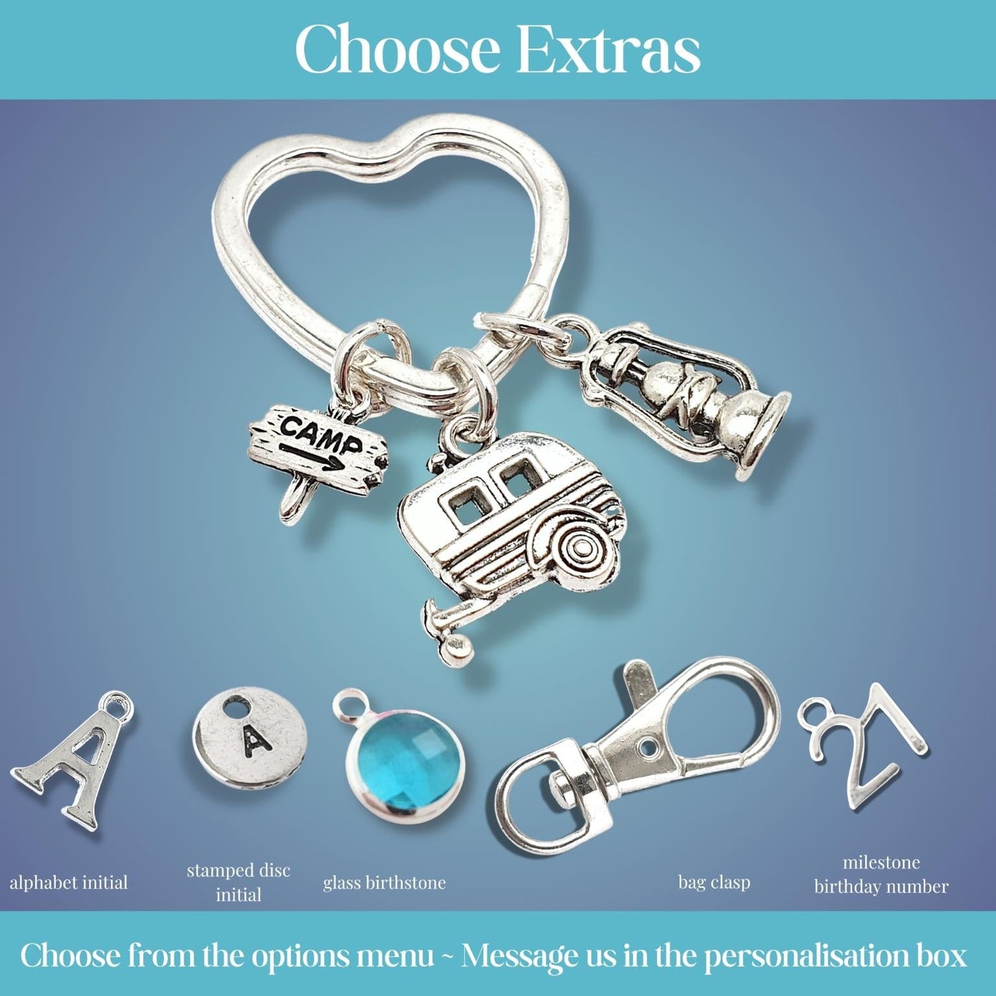 Silver keychain with various camping charms on a blue gradient background